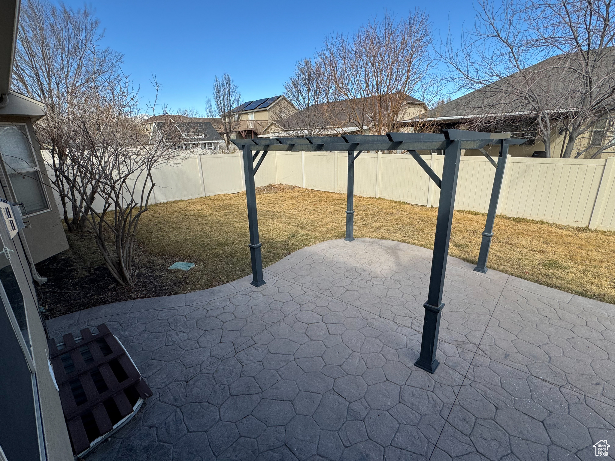 View of patio with a fenced backyard and a pergola