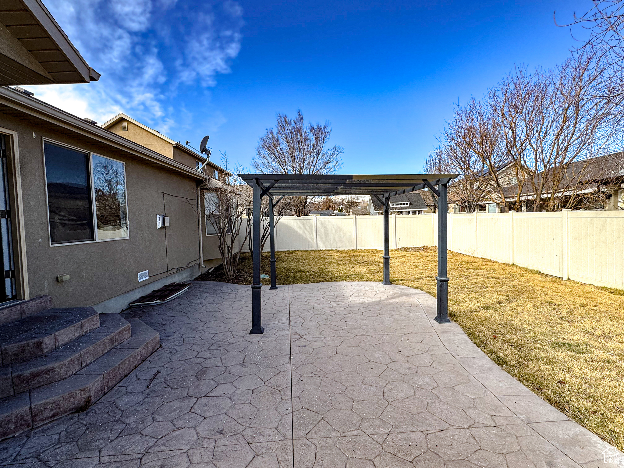 View of patio with a fenced backyard and a pergola