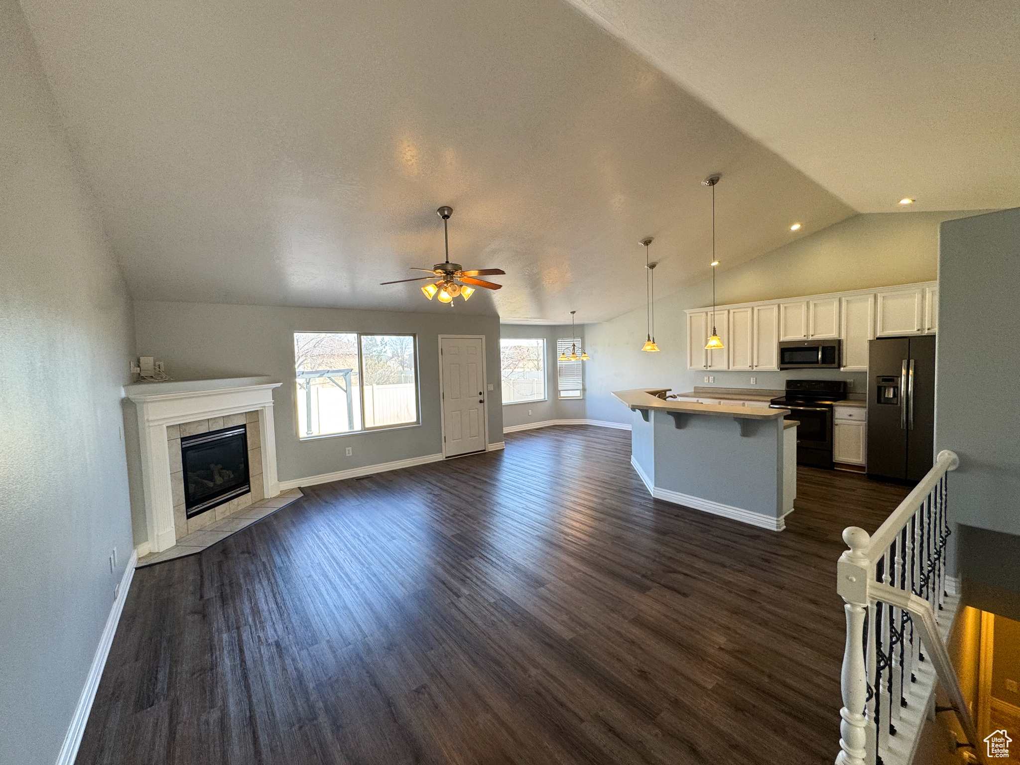 Kitchen with appliances with stainless steel finishes, a center island, open floor plan, and a breakfast bar area