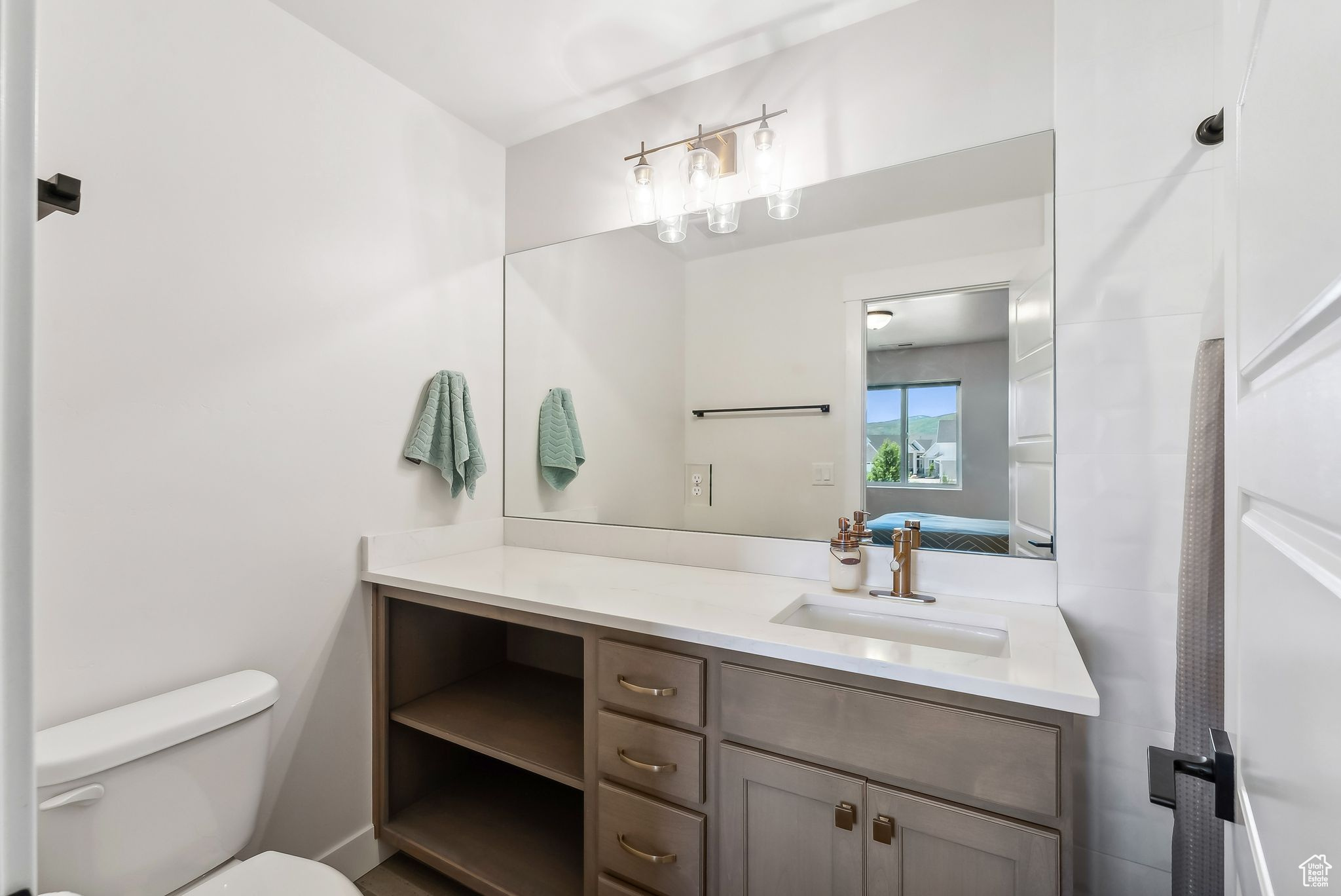 Ensuite bathroom featuring toilet, vanity, and ensuite bathroom