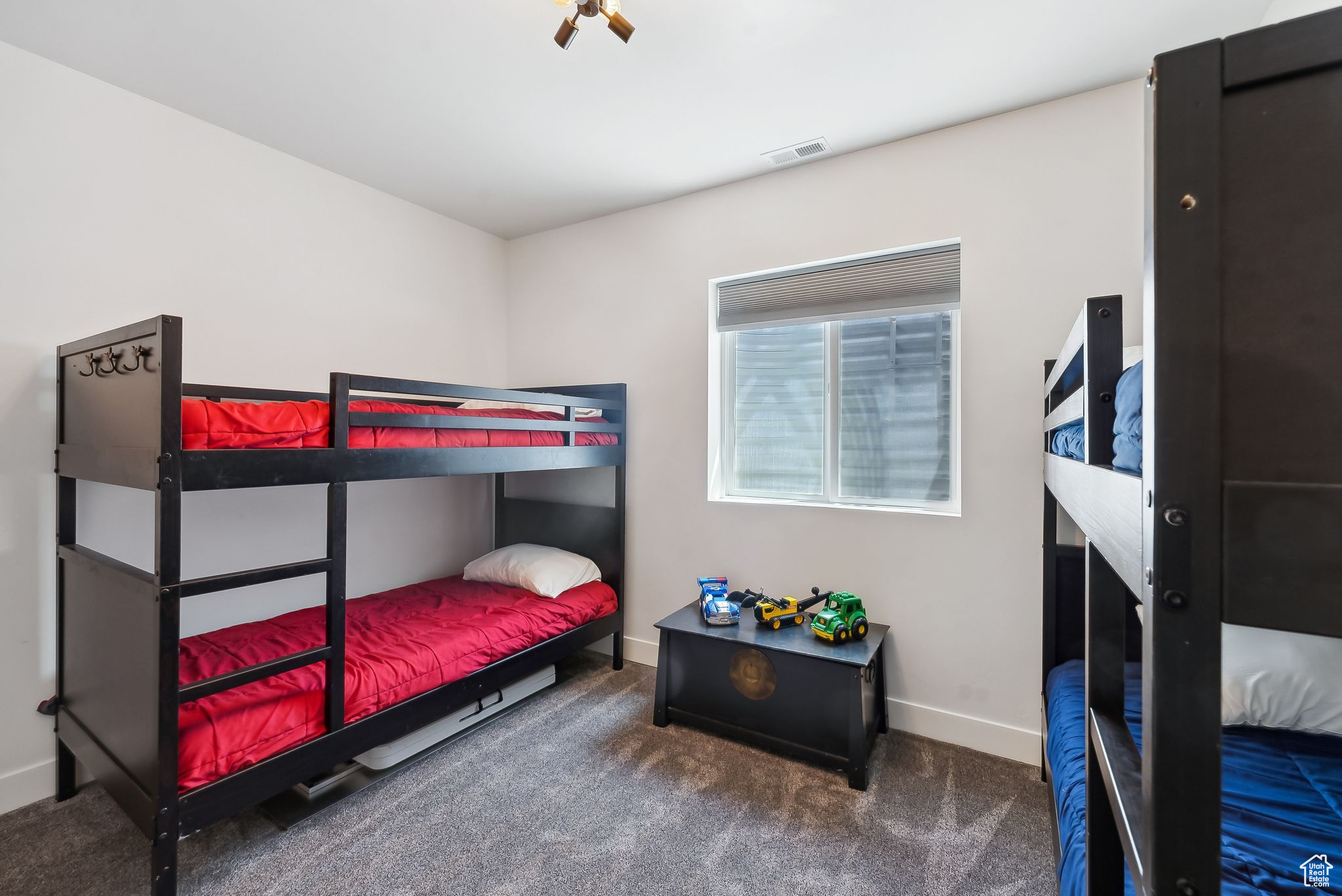 Carpeted bedroom with visible vents and baseboards