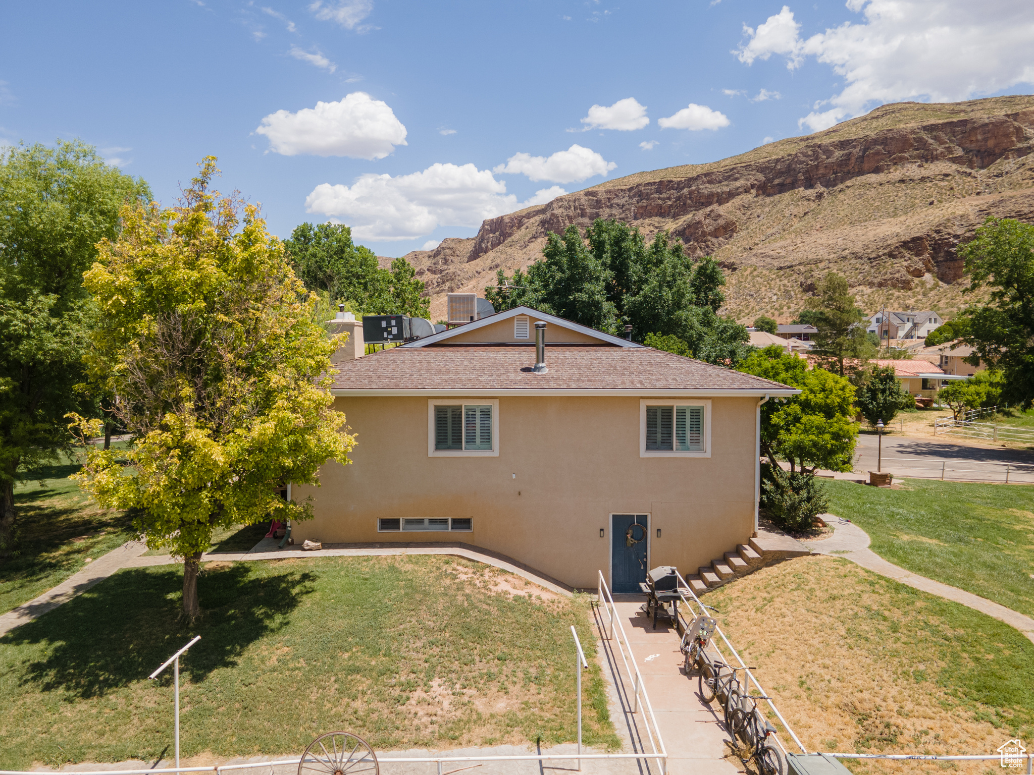 View of home's exterior with a mountain view and a lawn