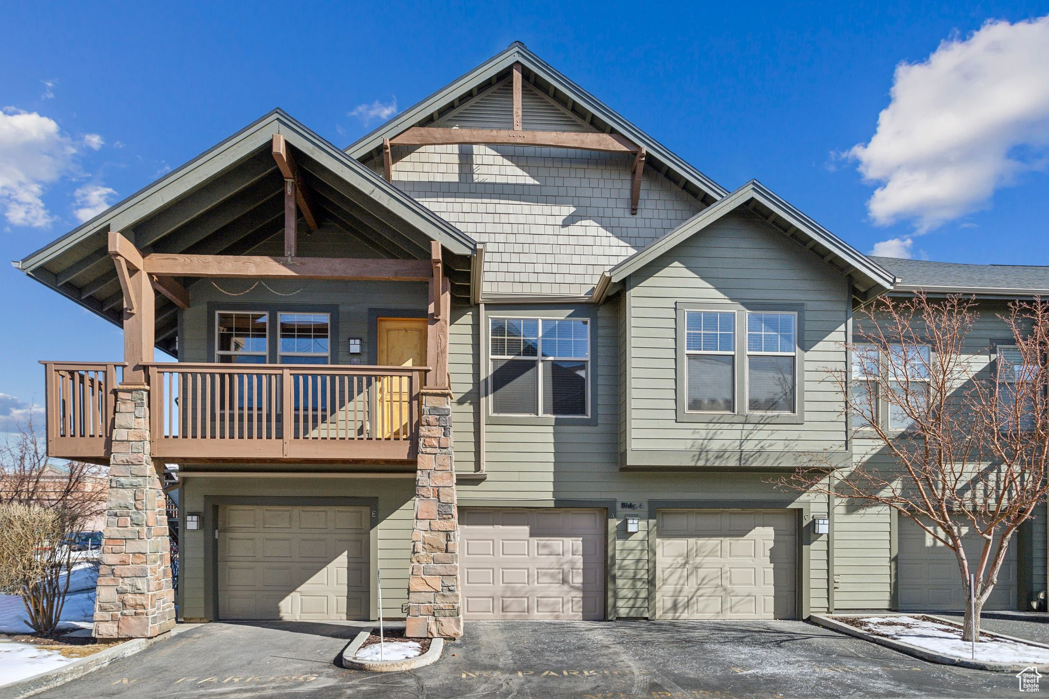 View of property with a balcony and an attached garage