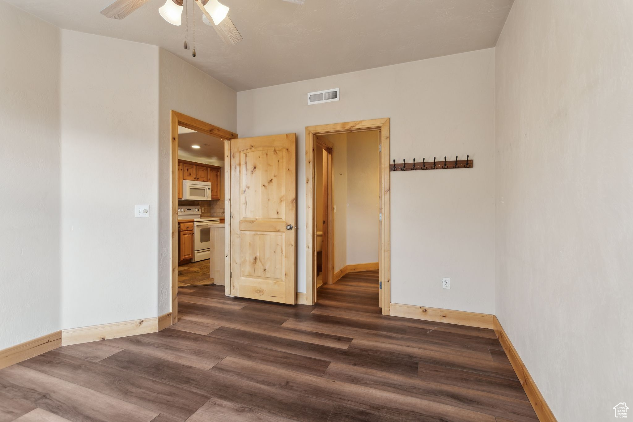 Primary Bedroom featuring ceiling fan and en-suite bathroom