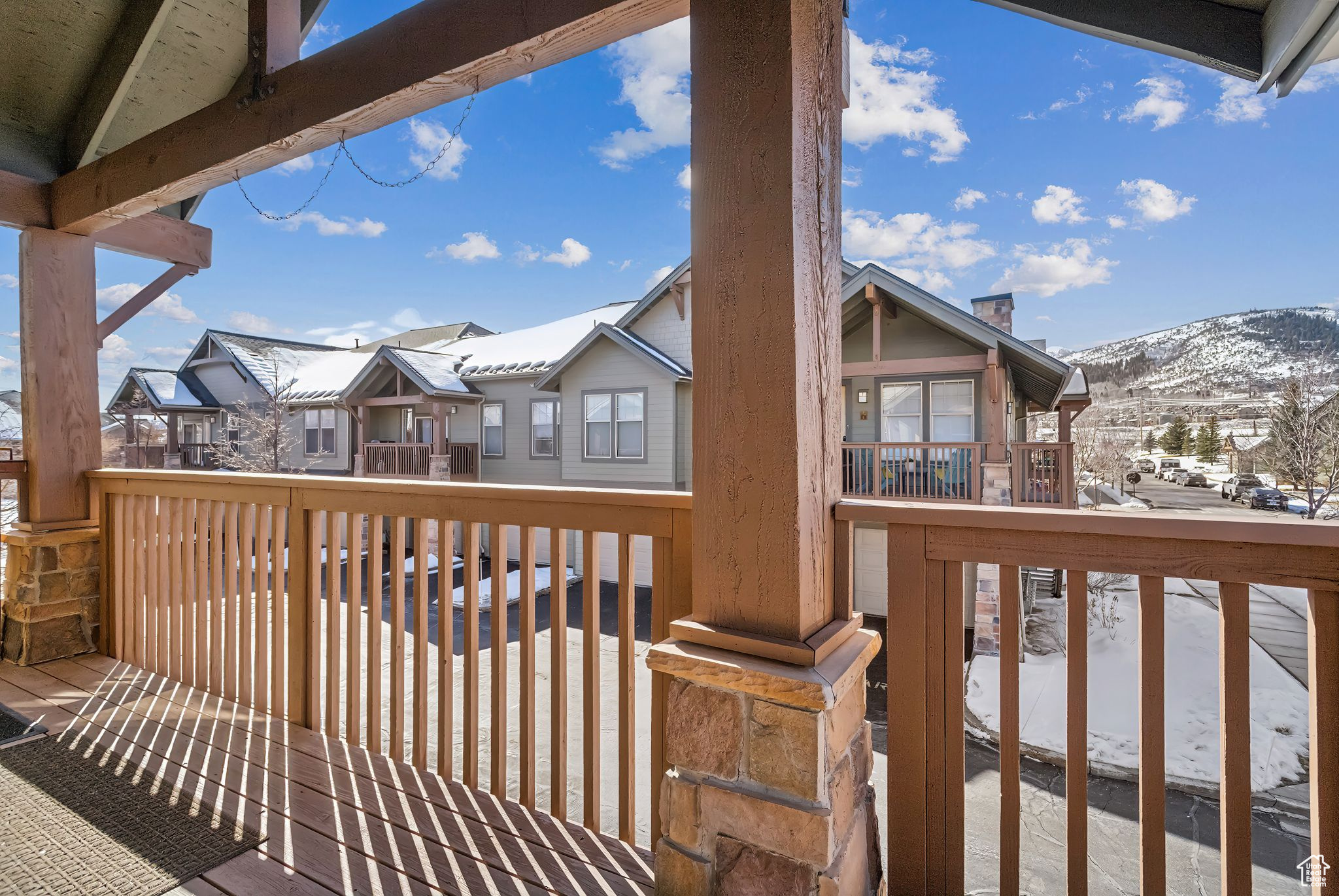 Snow covered deck featuring a mountain view