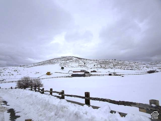 Snowy yard with a mountain view
