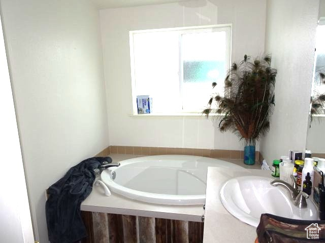 Bathroom featuring a bath and a sink