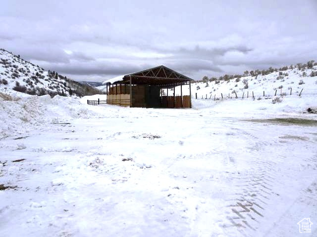 Snowy yard featuring a mountain view