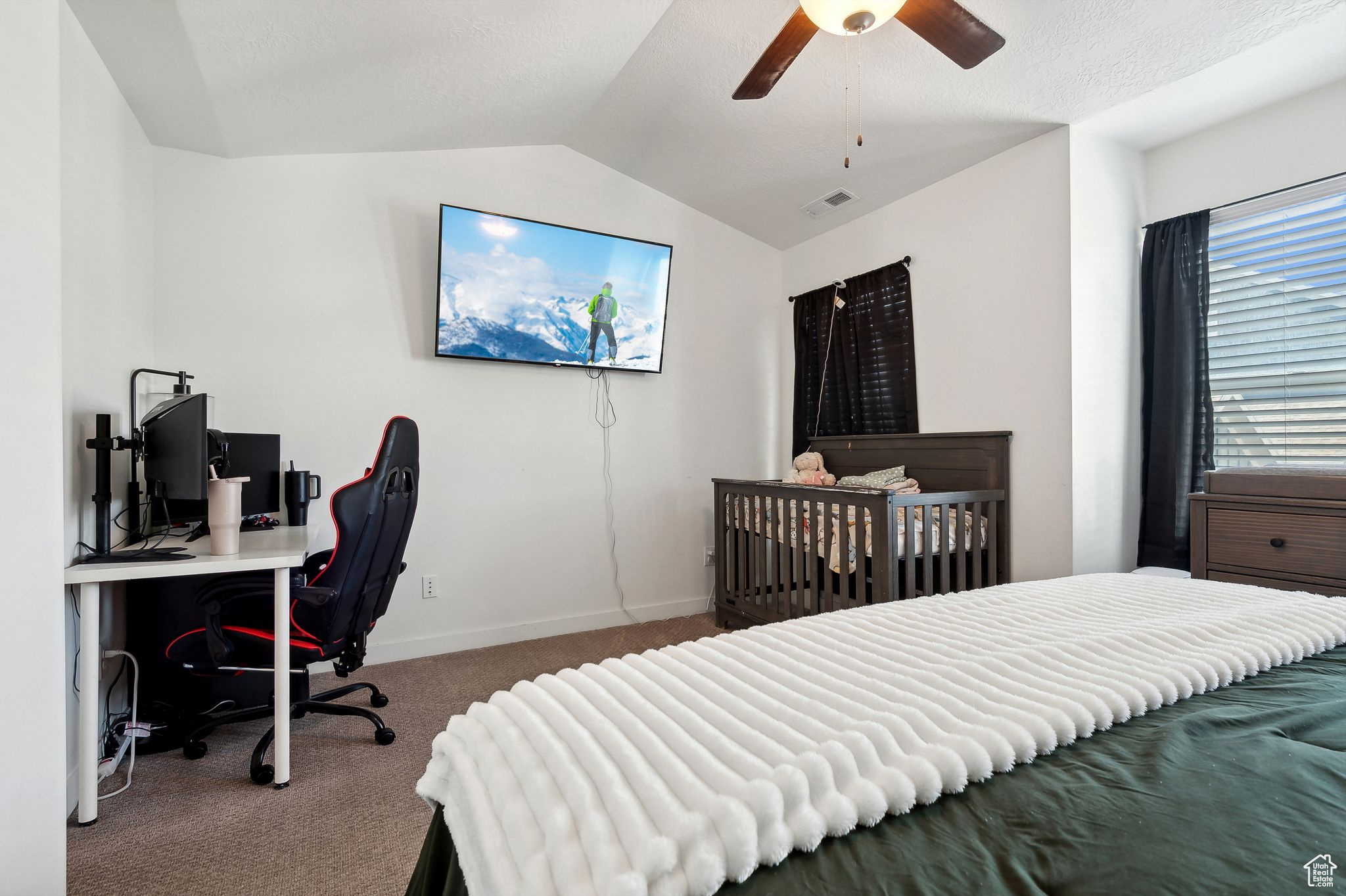 Bedroom with visible vents, baseboards, a ceiling fan, carpet, and vaulted ceiling