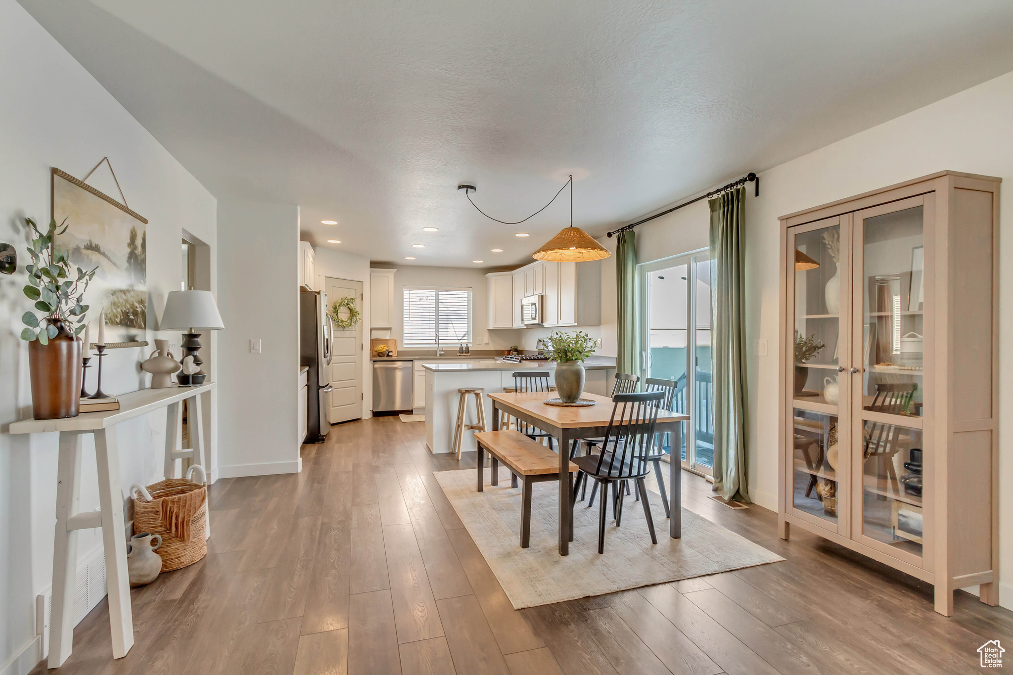 Dining room featuring light wood finished floors, baseboards, and recessed lighting