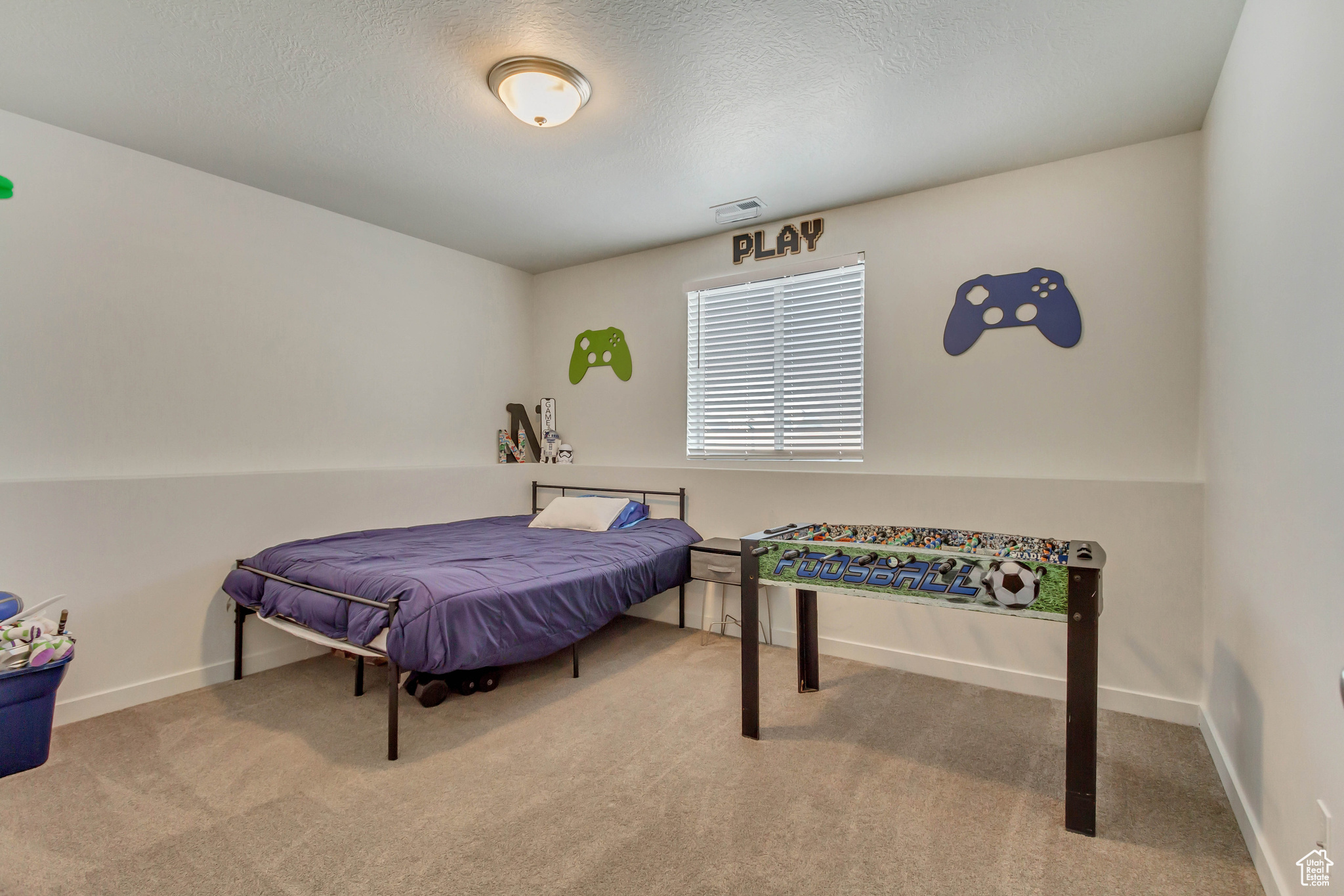 Bedroom featuring baseboards, a textured ceiling, visible vents, and carpet flooring