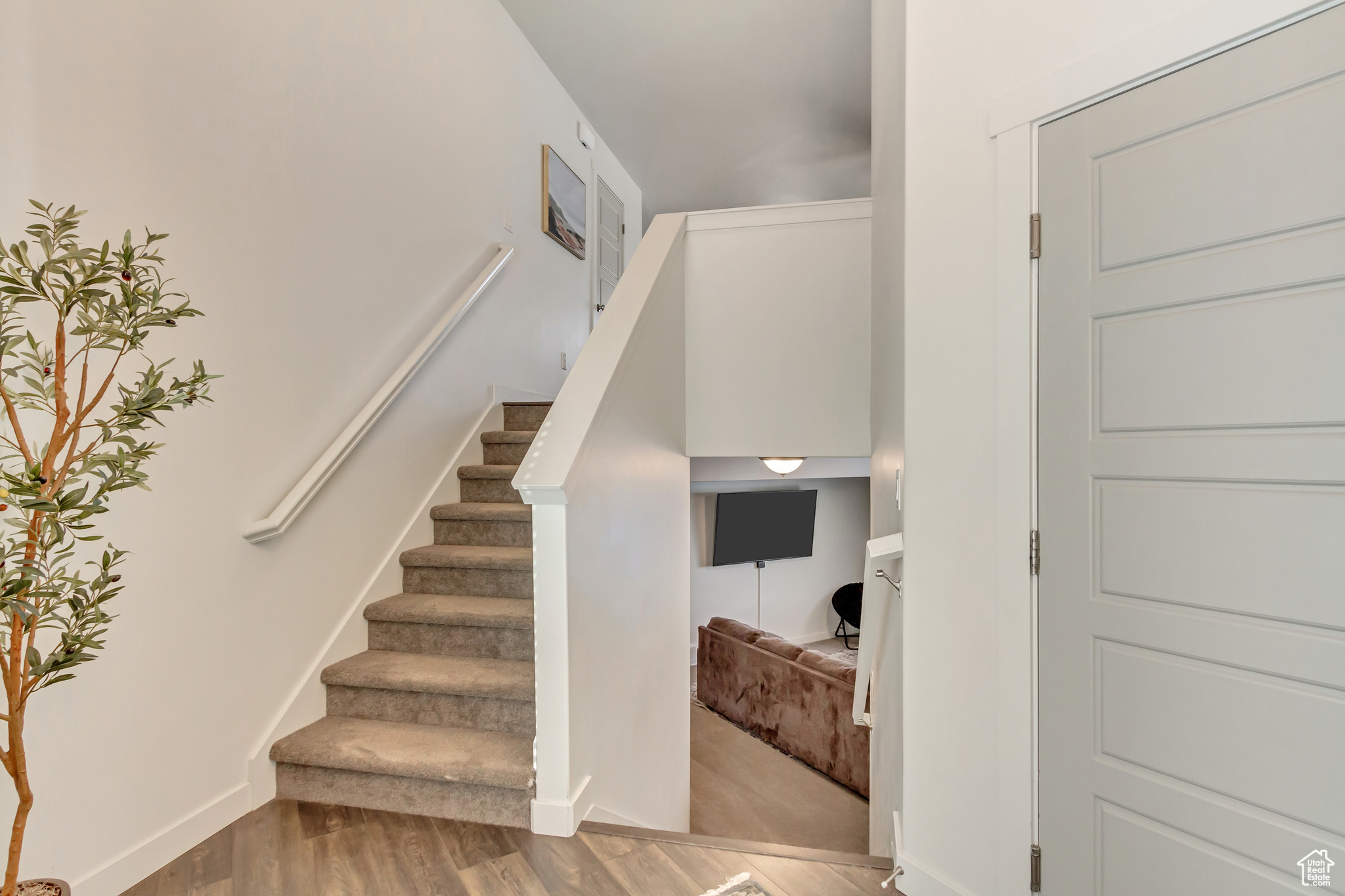 Stairway with baseboards and wood finished floors