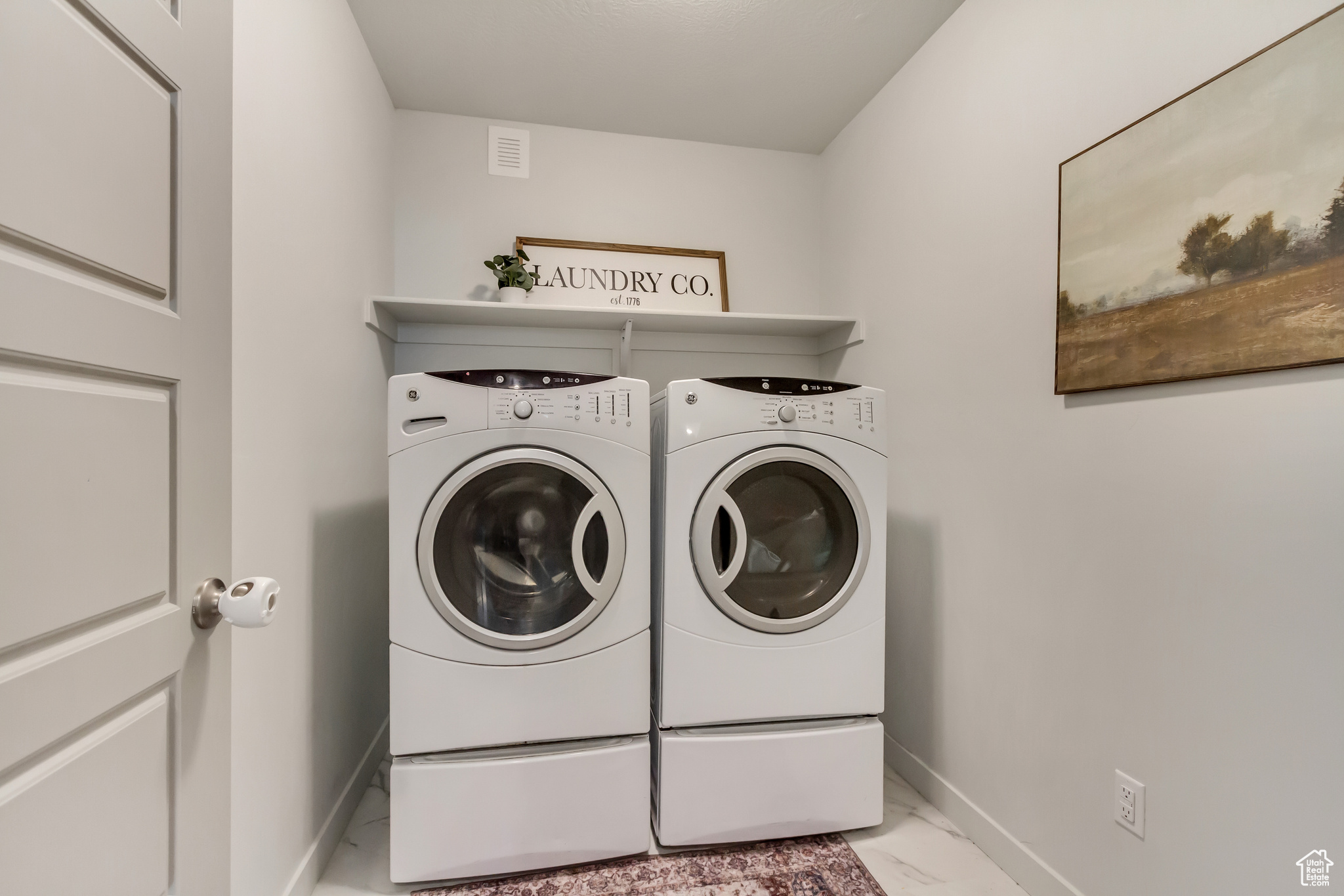 Washroom featuring laundry area, baseboards, marble finish floor, and independent washer and dryer