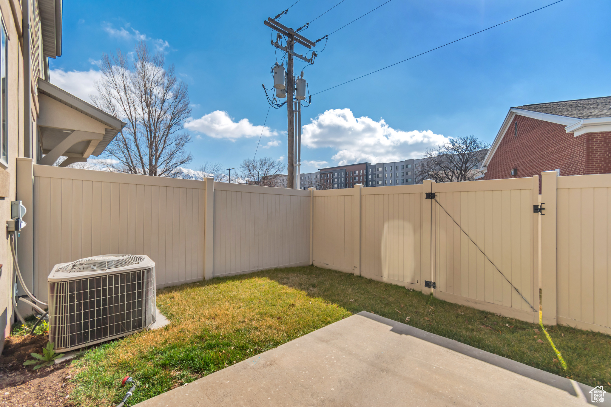 View of yard with a patio, a gate, cooling unit, and a fenced backyard