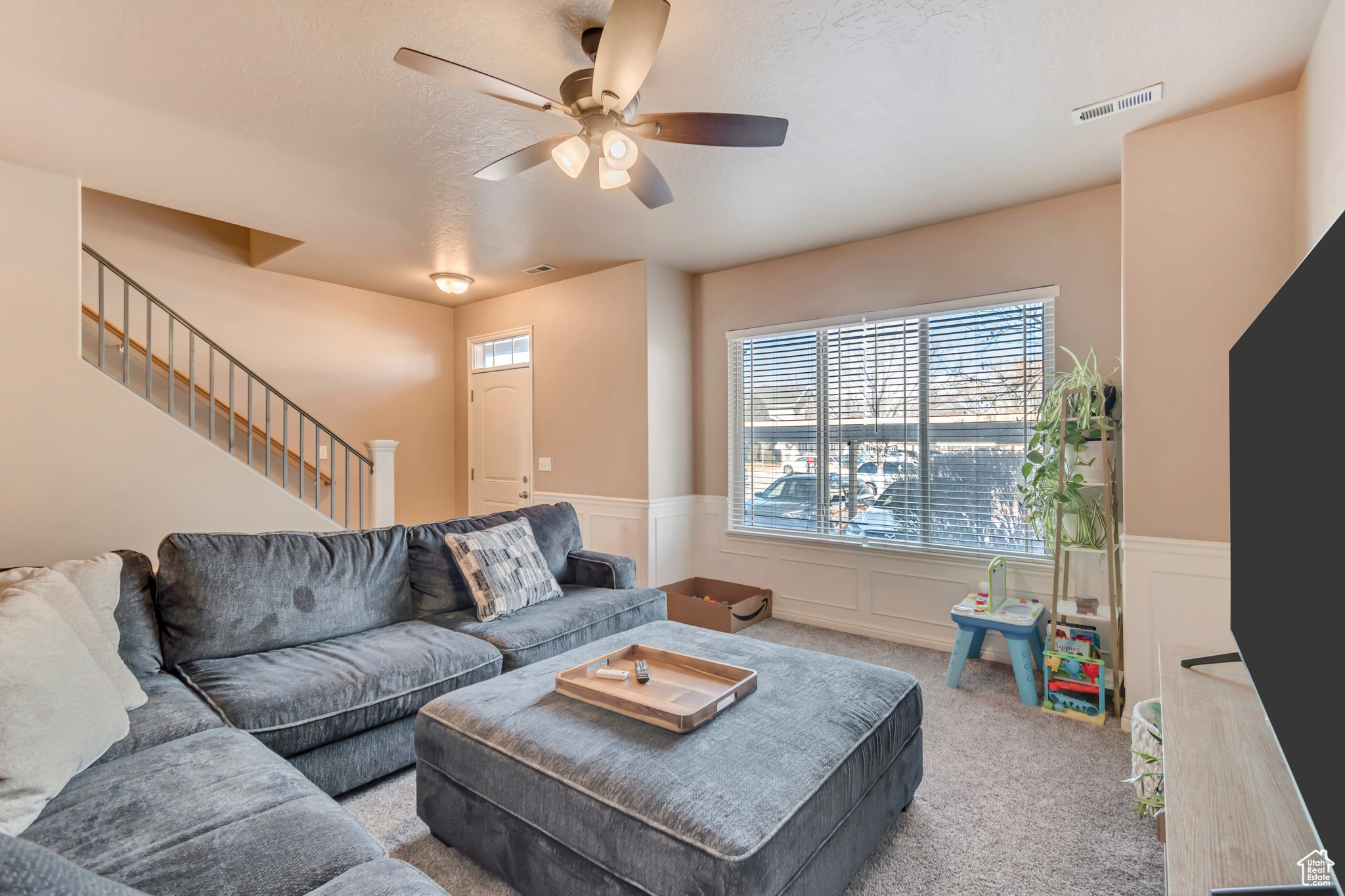 Living room and entry with stairs going up to second level