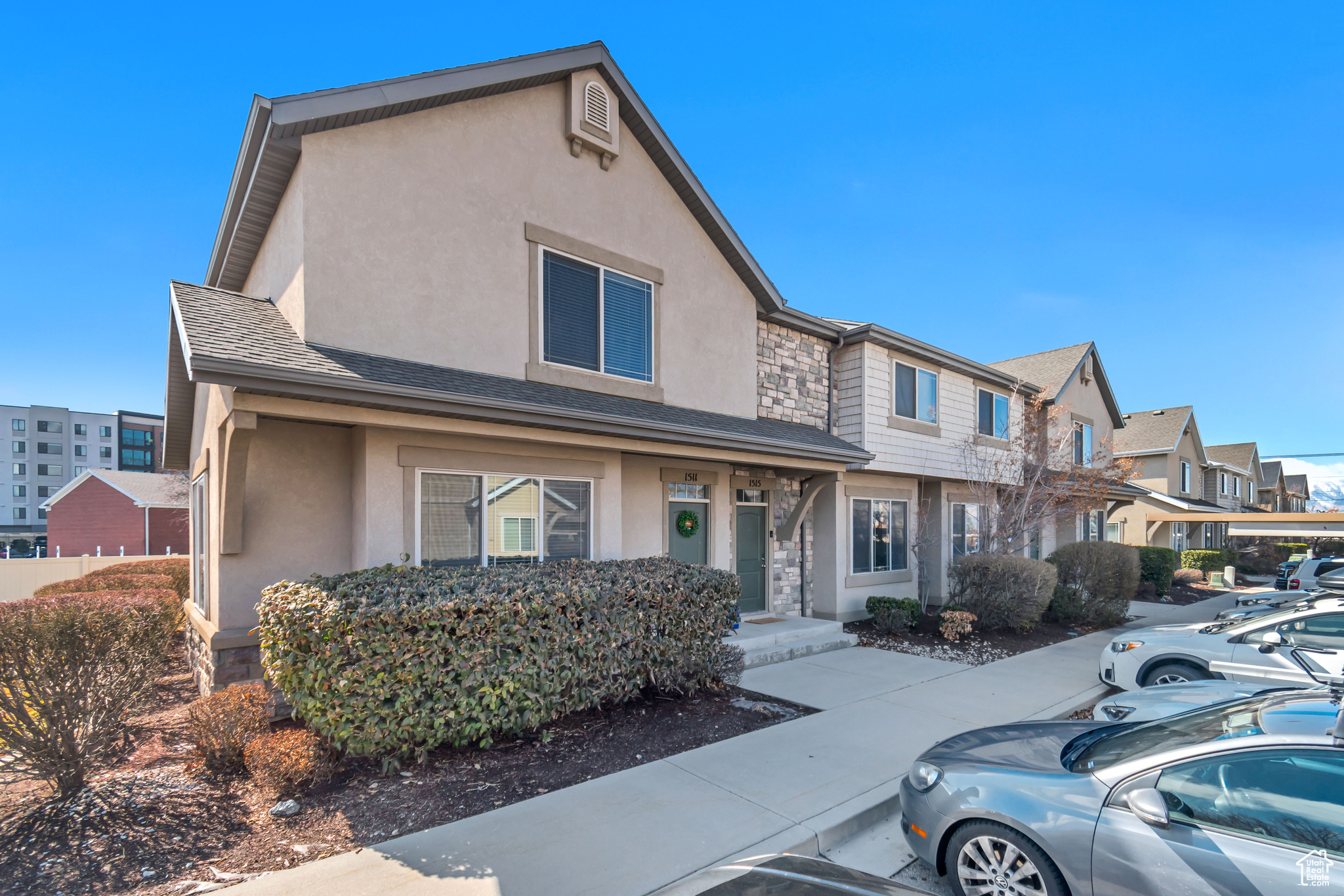 Front of property with HOA maintained landscaping