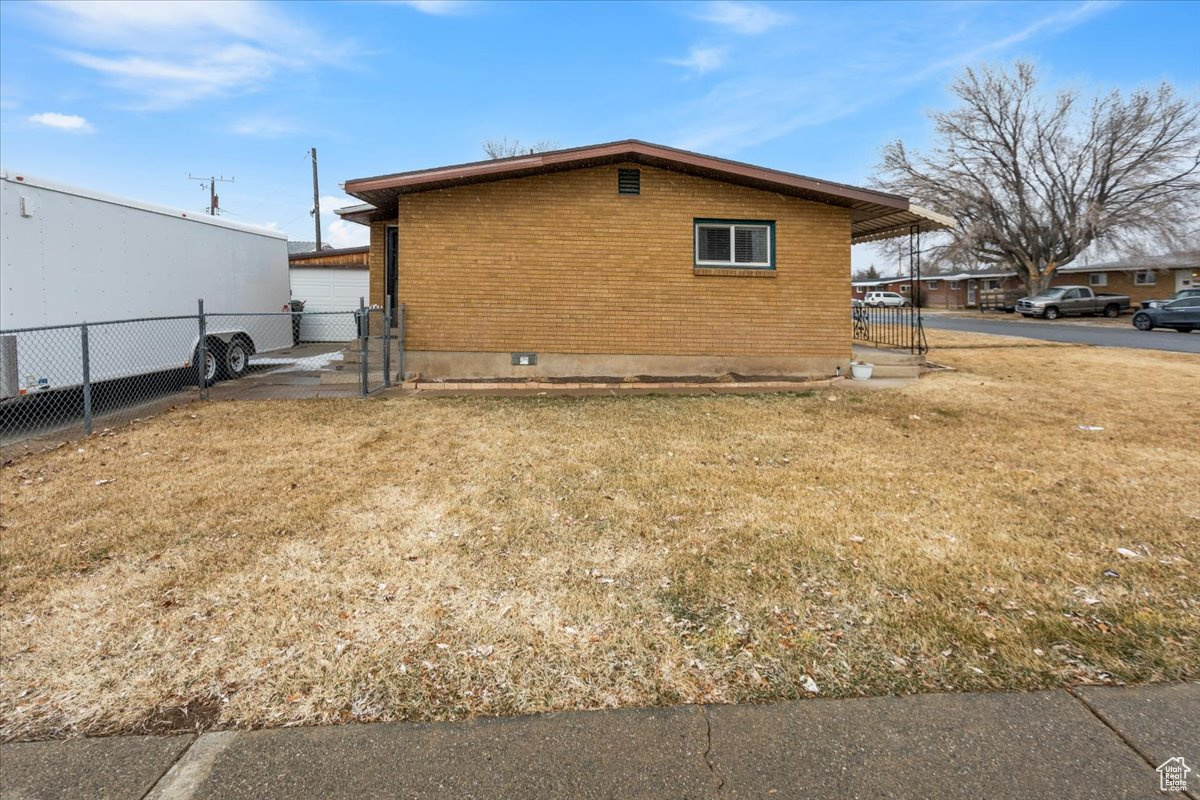 View of home's exterior with a yard