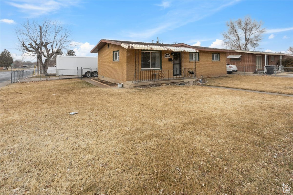 Rear view of property featuring a yard