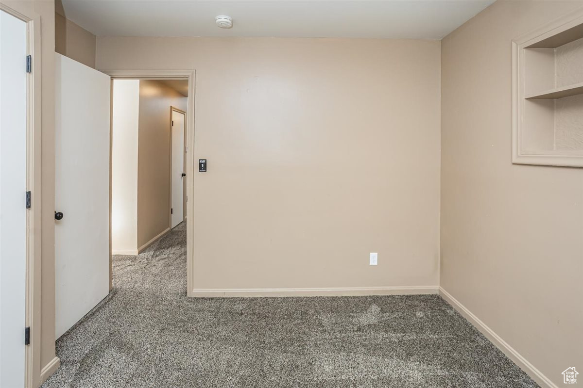 Unfurnished room featuring carpet flooring and baseboards