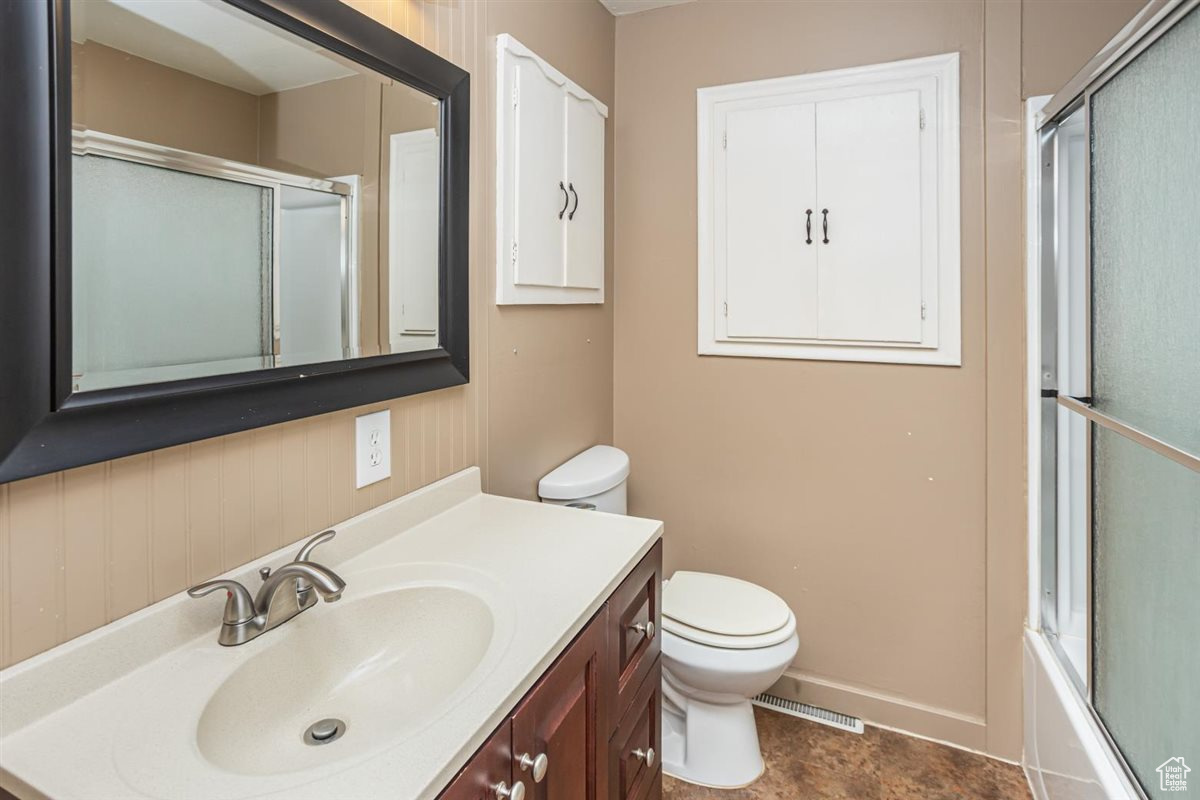 Full bath featuring visible vents, vanity, and toilet