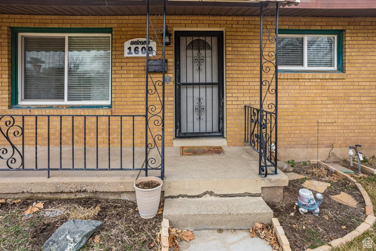 View of exterior entry with brick siding