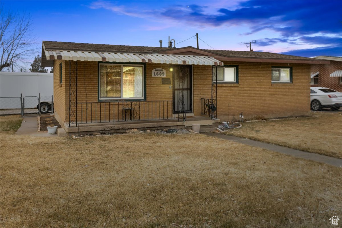 View of front of property with a lawn