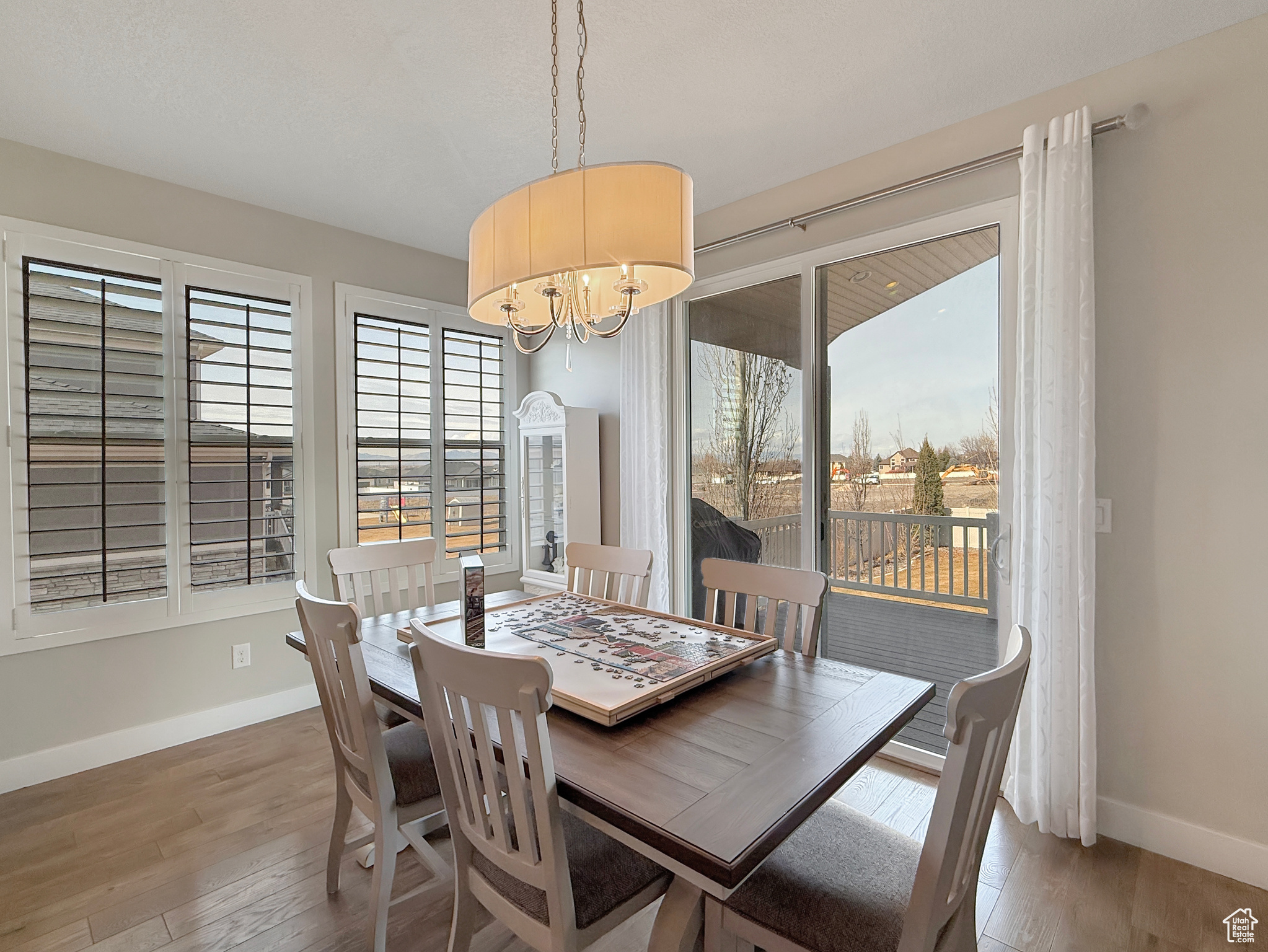 Dining space featuring a chandelier, wood finished floors, and baseboards