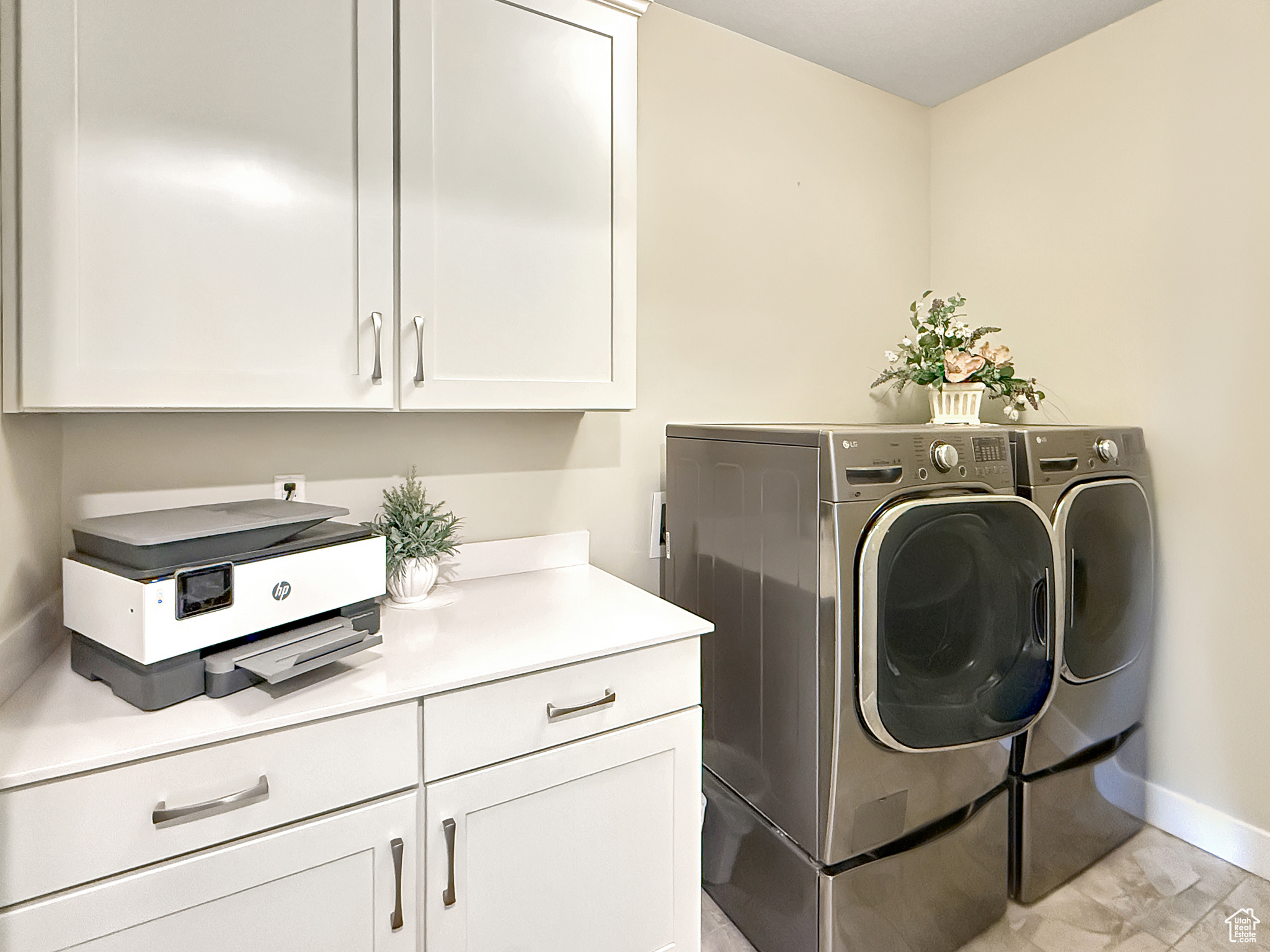 Laundry area featuring cabinet space, independent washer and dryer, and baseboards