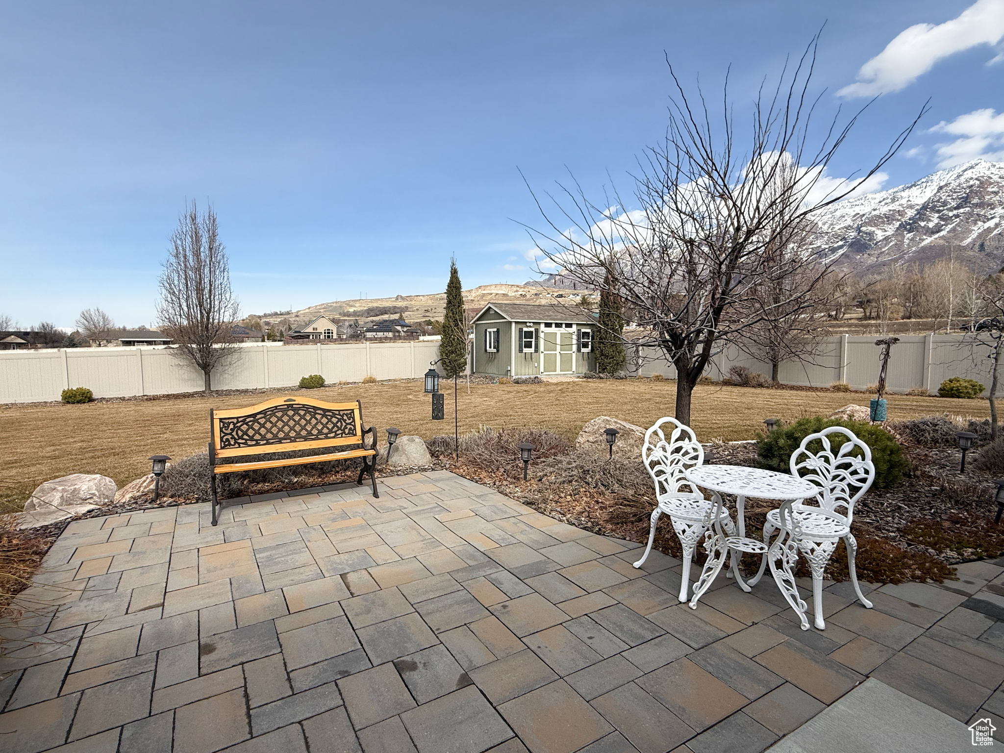 View of patio / terrace featuring a fenced backyard, a mountain view, and an outbuilding