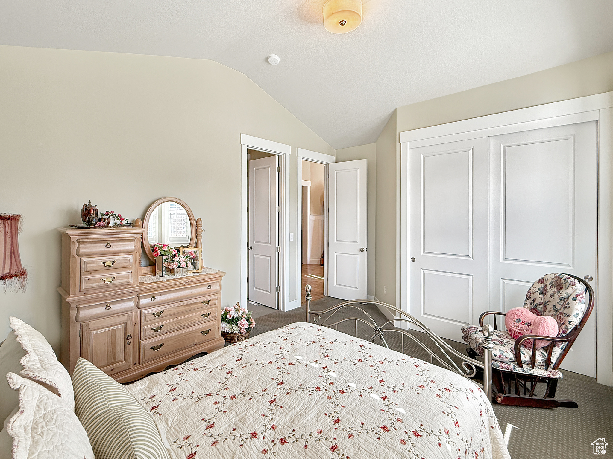 Bedroom featuring lofted ceiling, a closet, and carpet