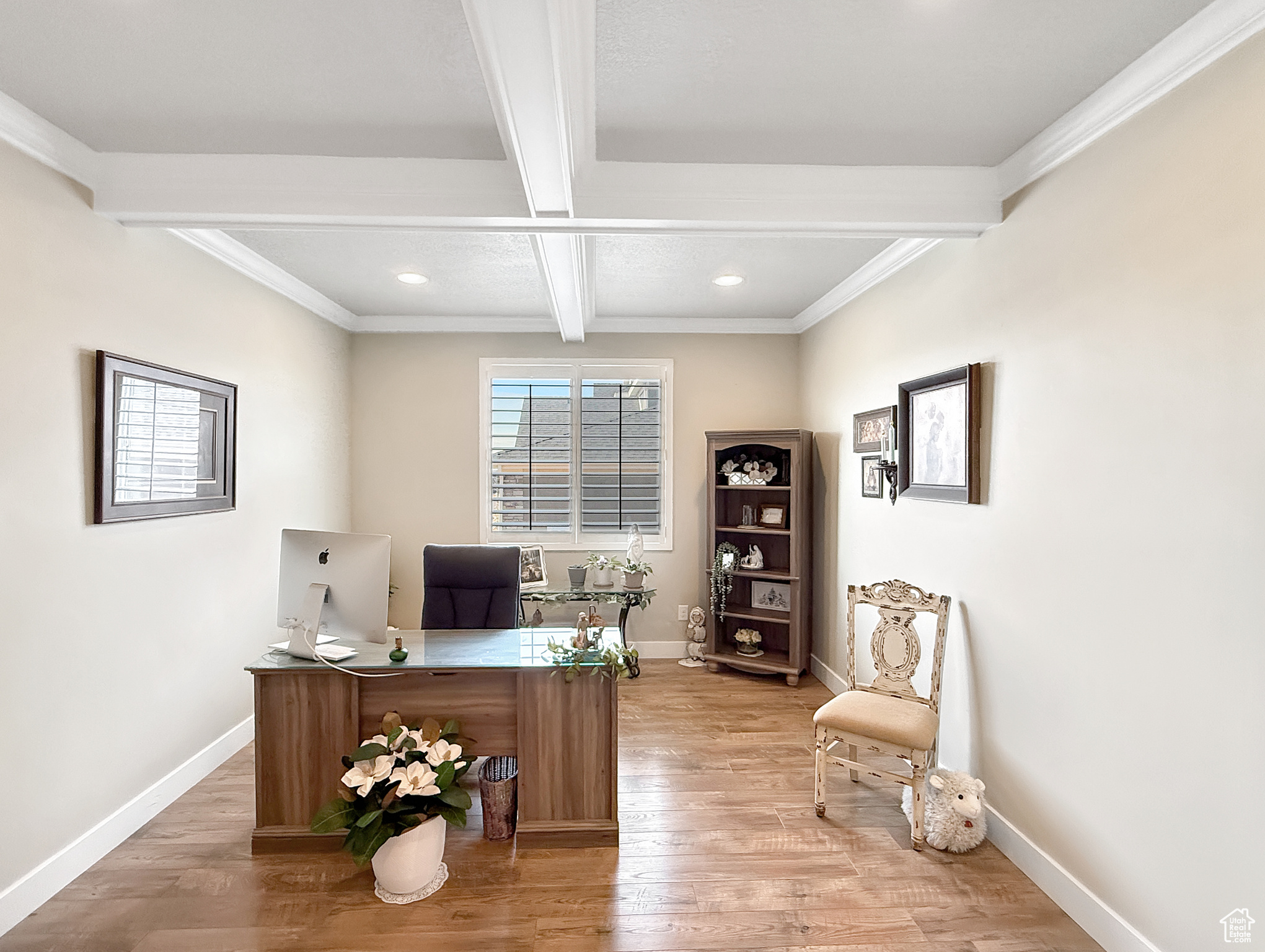 Office area with beamed ceiling, light wood-style flooring, and baseboards