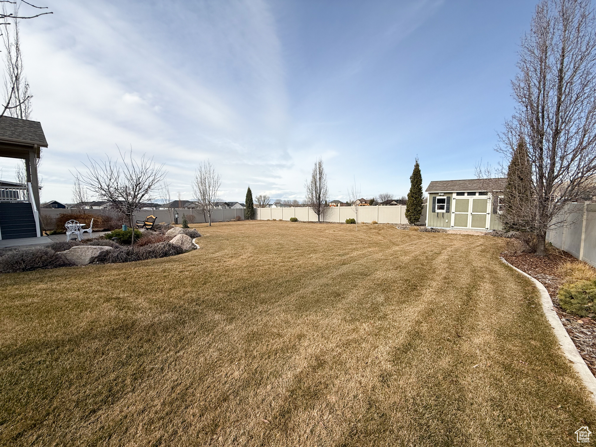 View of yard with a storage shed, a fenced backyard, and an outdoor structure