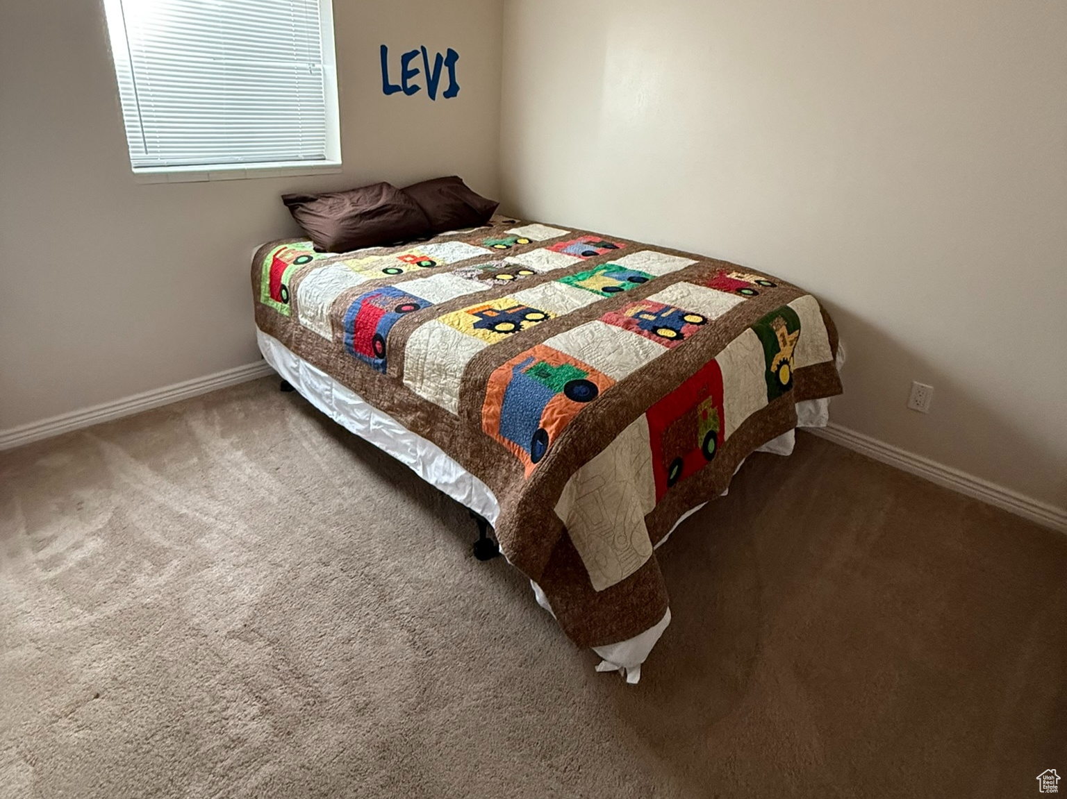 Carpeted bedroom with baseboards