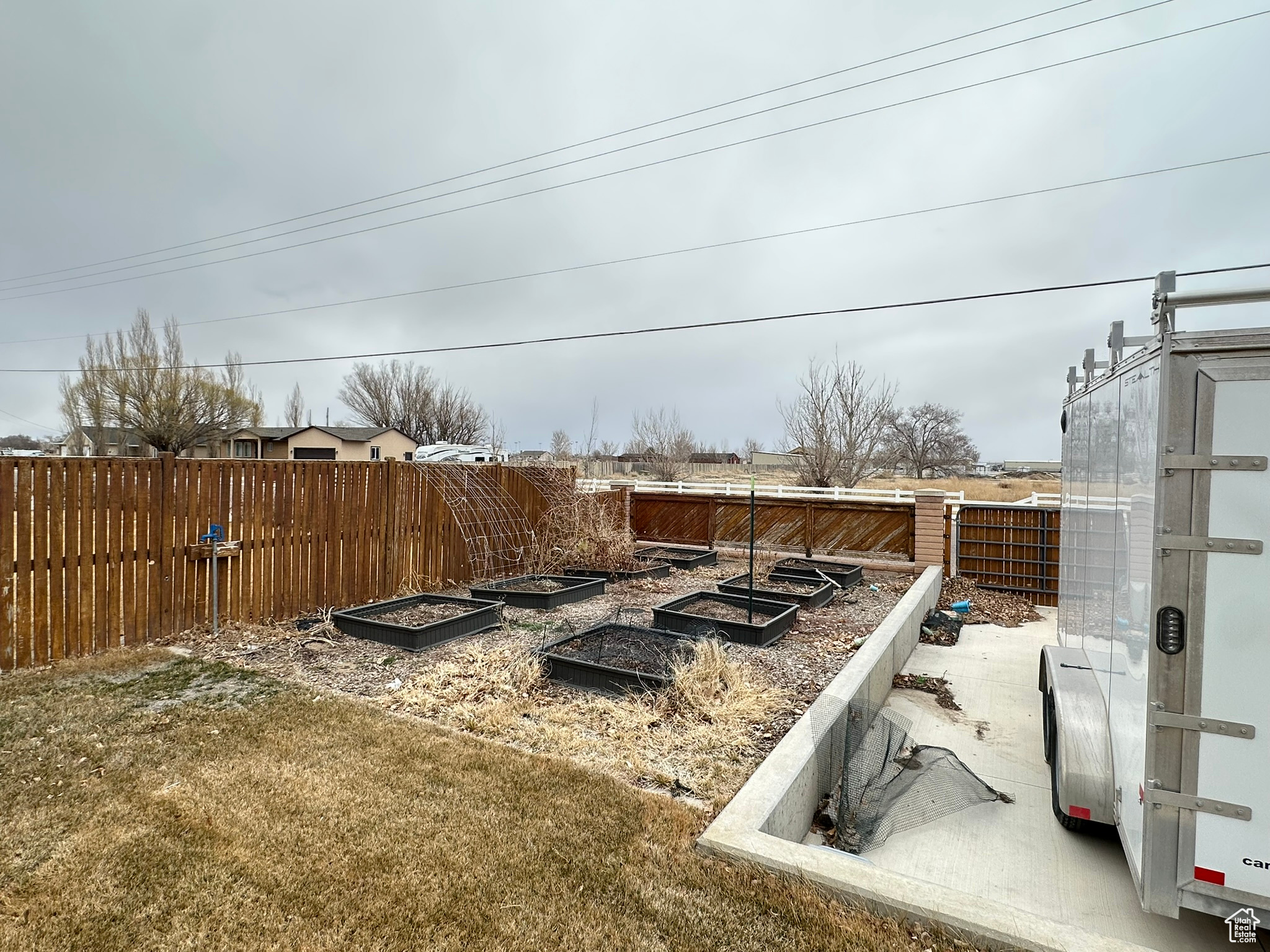 View of yard with a vegetable garden and fence