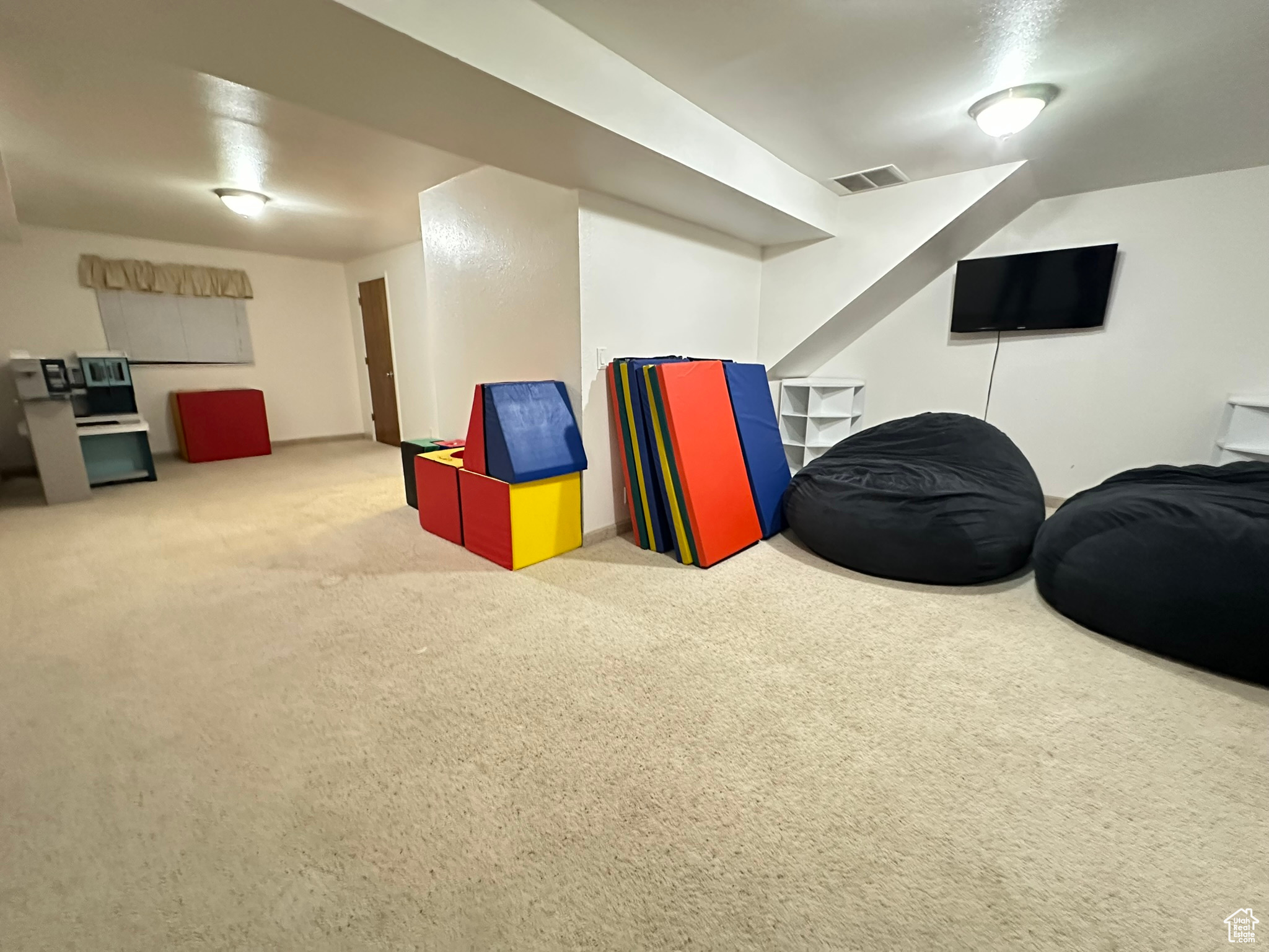 Rec room featuring carpet and visible vents