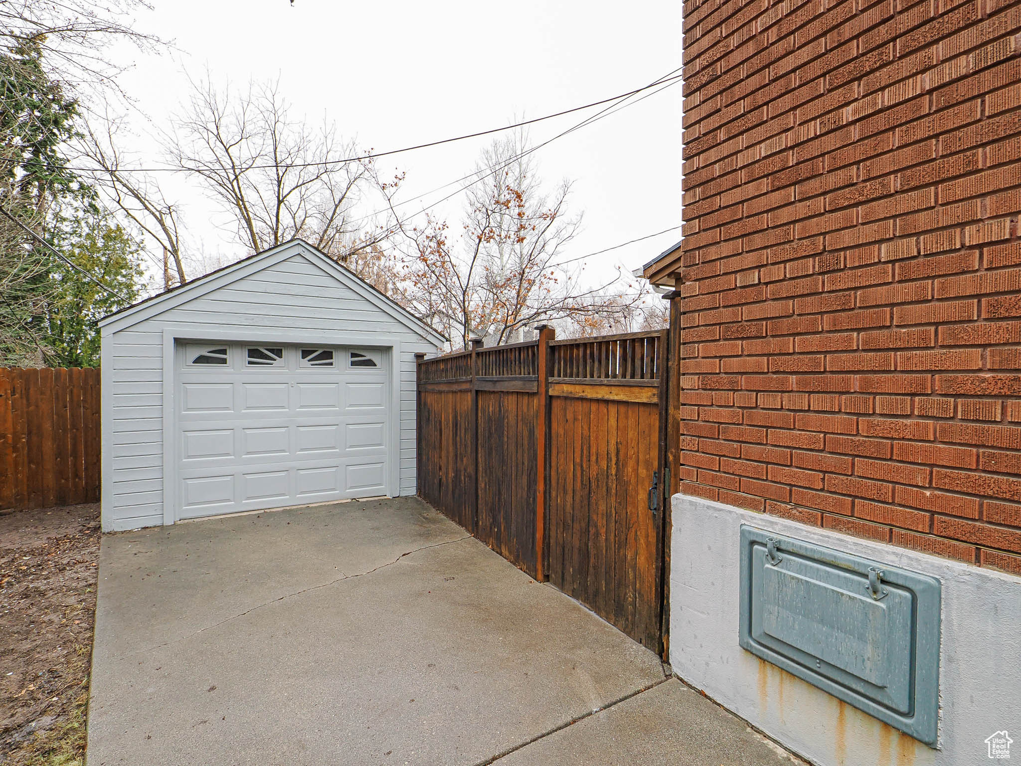 Detached garage featuring driveway and fence