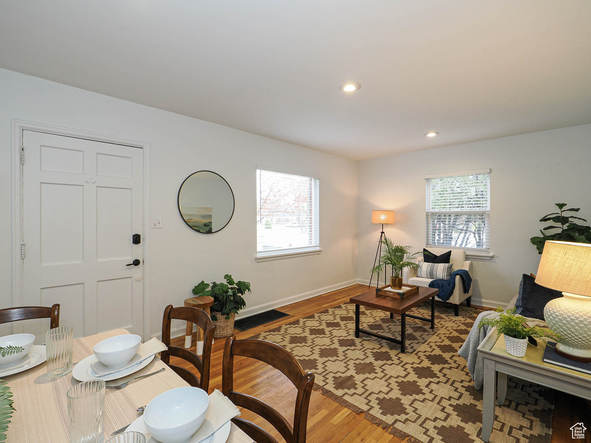 Living room featuring light wood-style flooring, baseboards, a wealth of natural light, and recessed lighting