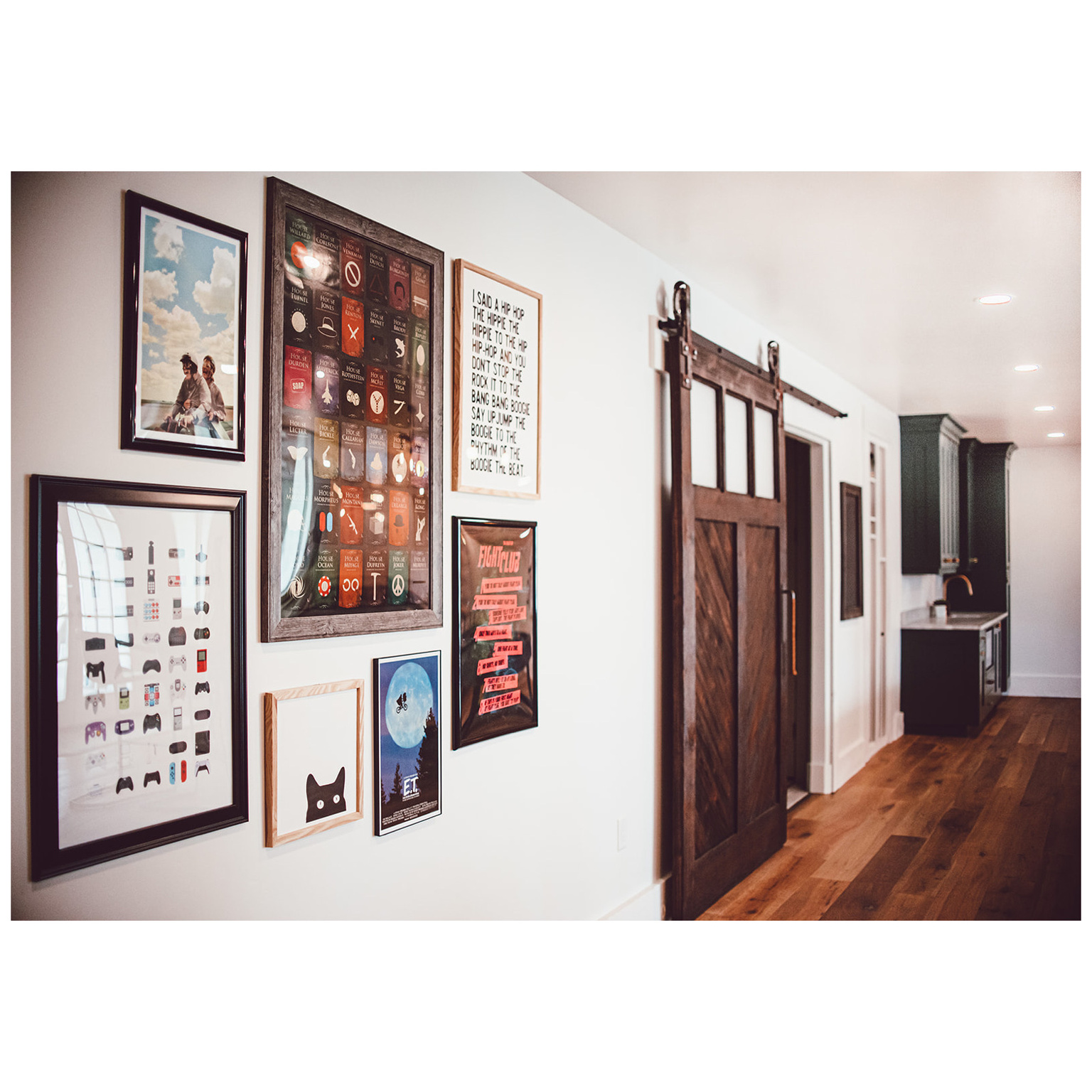 Corridor featuring a sink, a barn door, dark wood finished floors, and baseboards