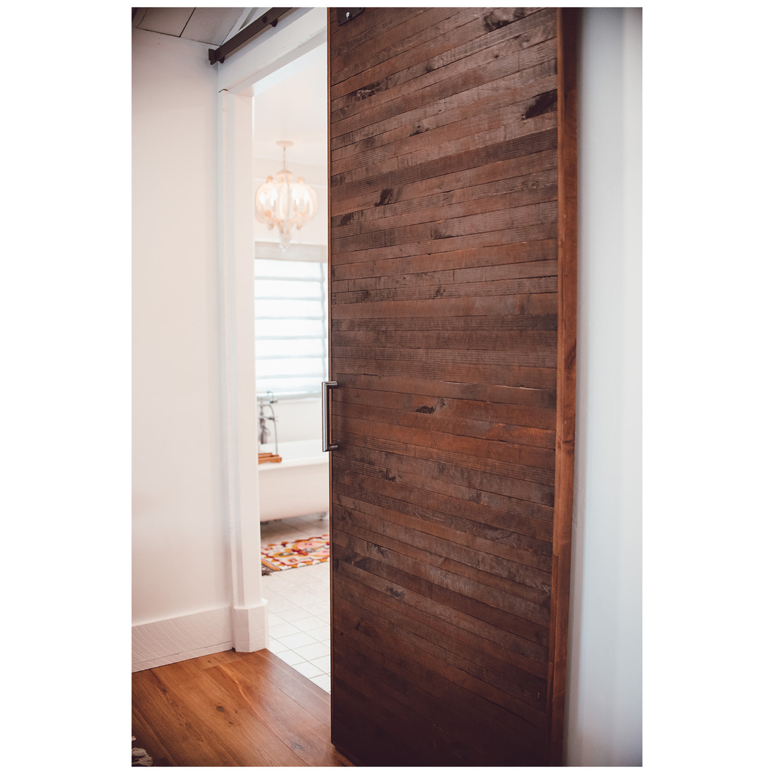 Hallway with wooden walls and wood finished floors