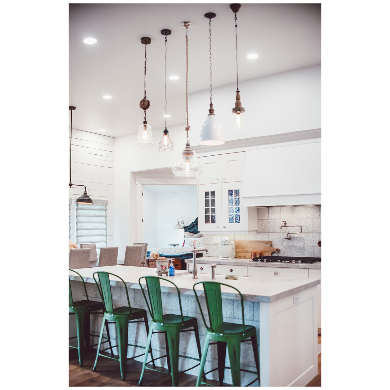 Kitchen featuring a kitchen bar, white cabinetry, decorative backsplash, and gas cooktop