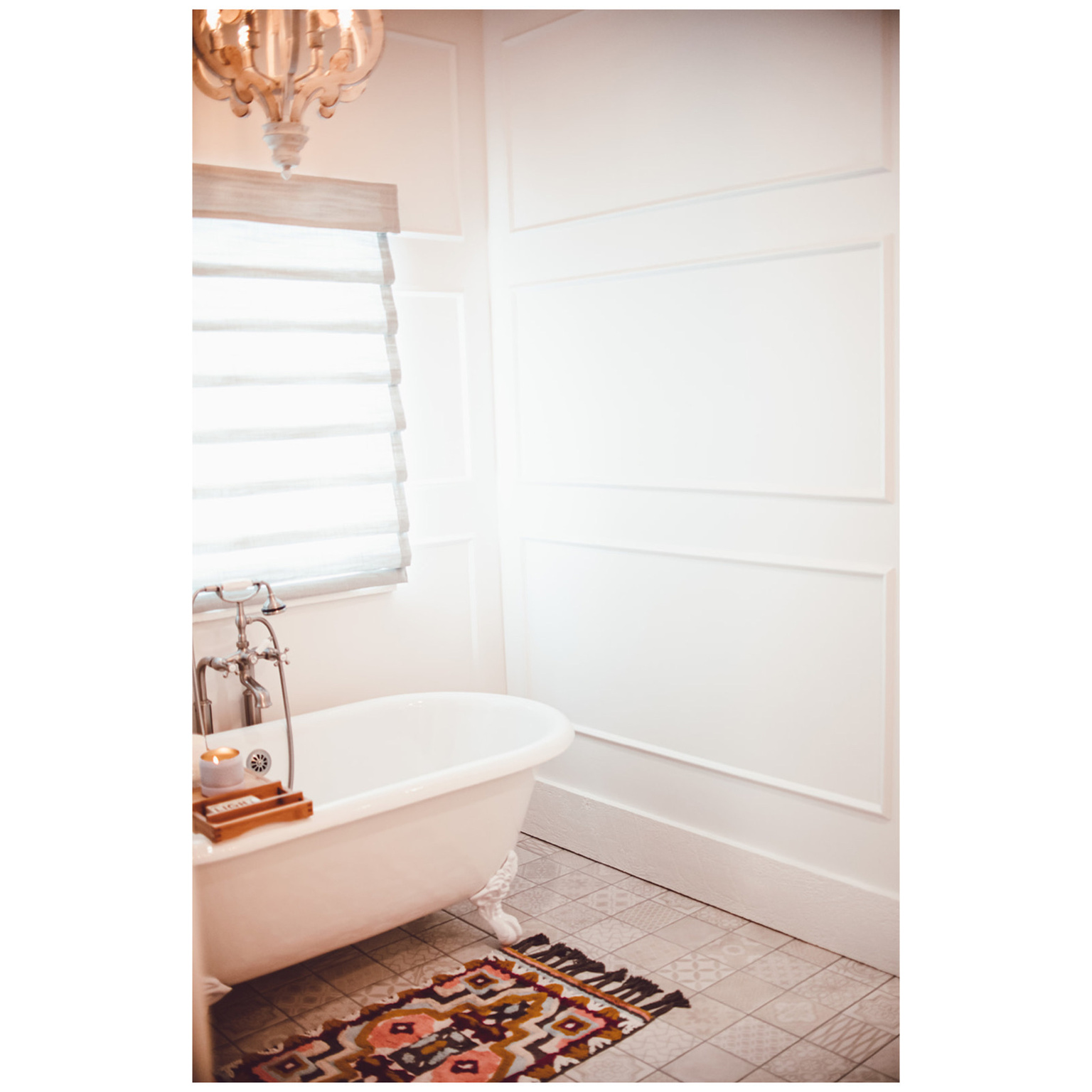 Bathroom with tile patterned flooring, a chandelier, and a freestanding bath