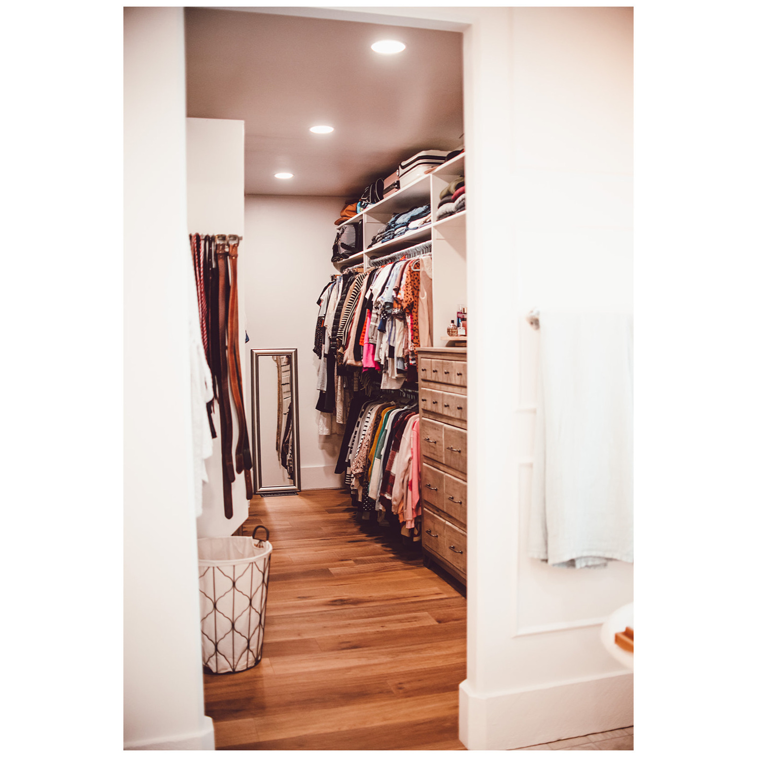 Walk in closet with light wood-style flooring