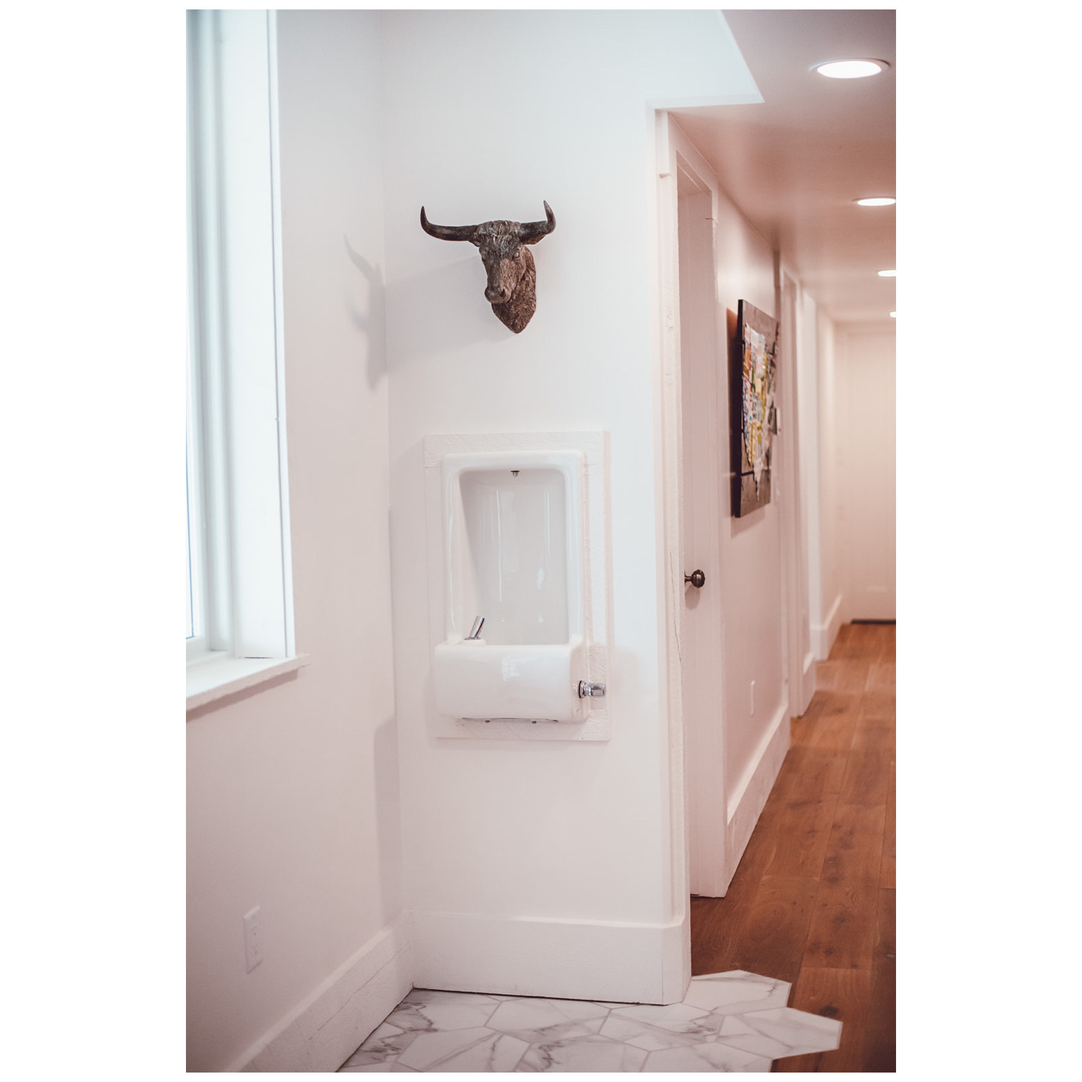 Corridor featuring marble finish floor, recessed lighting, and baseboards