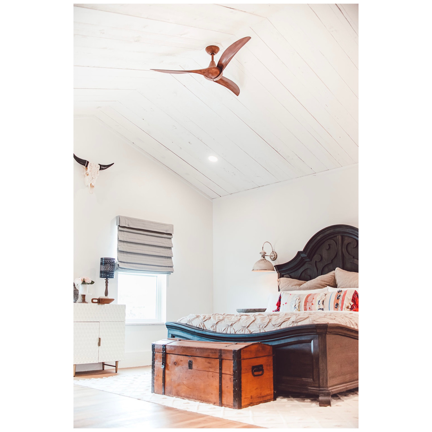 Bedroom with a ceiling fan, vaulted ceiling, and wood finished floors