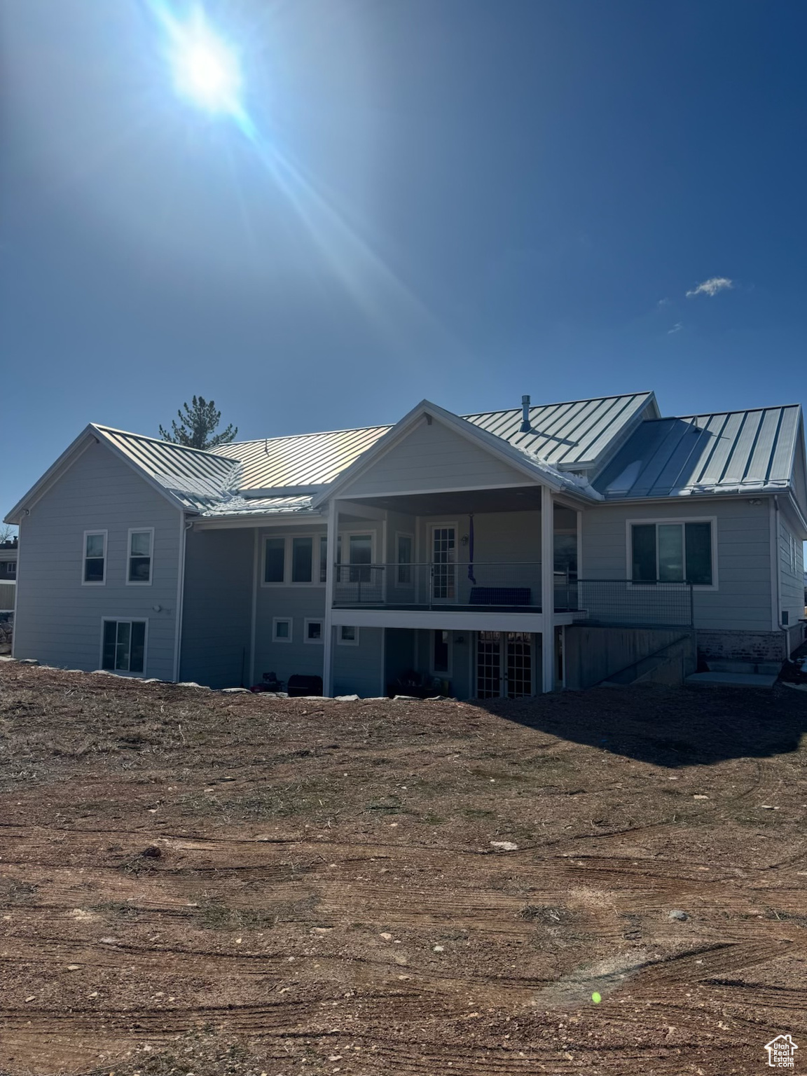 Rear view of property with metal roof and a standing seam roof