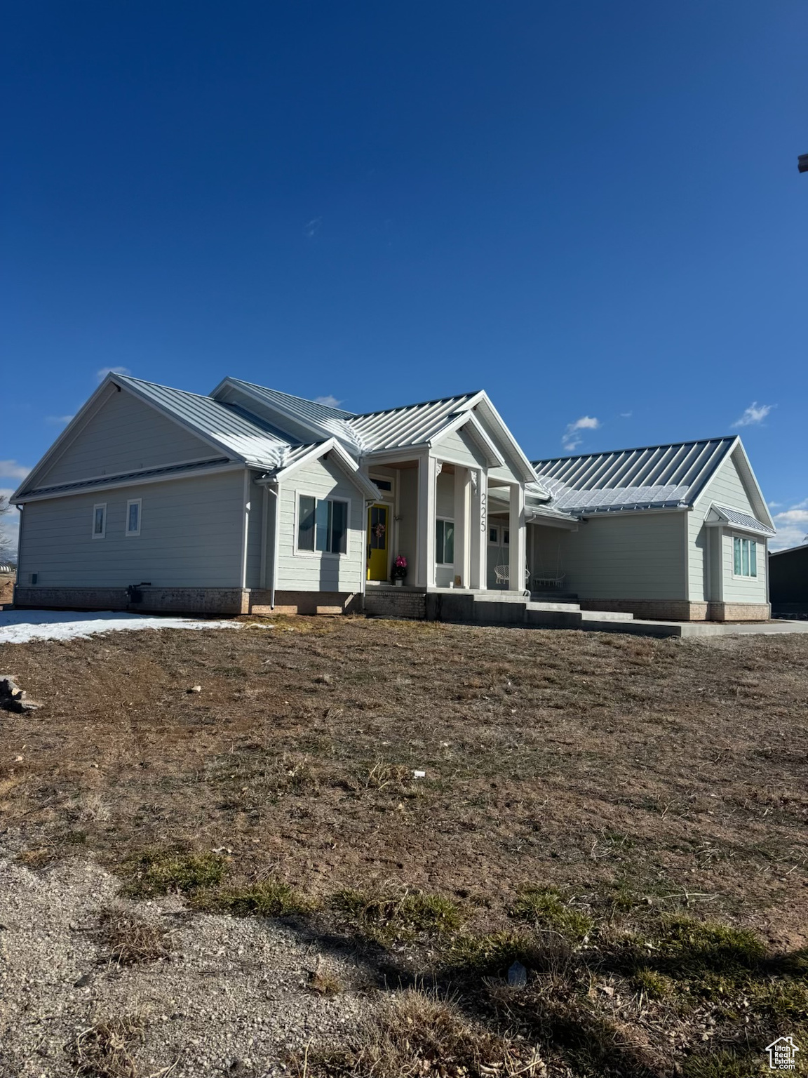 Single story home featuring a standing seam roof and metal roof