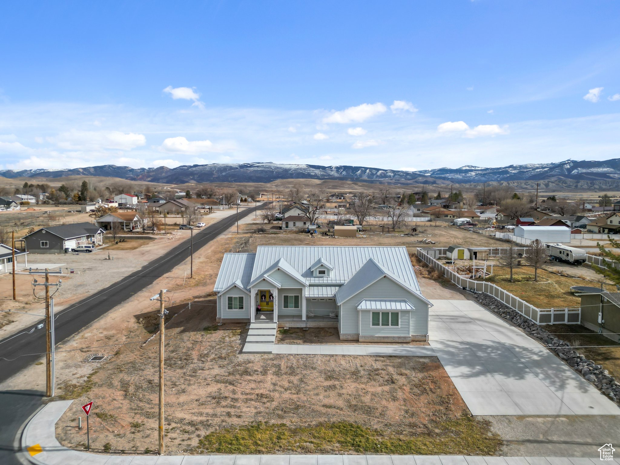 View of front of home featuring a residential view, metal roof, and a mountain view