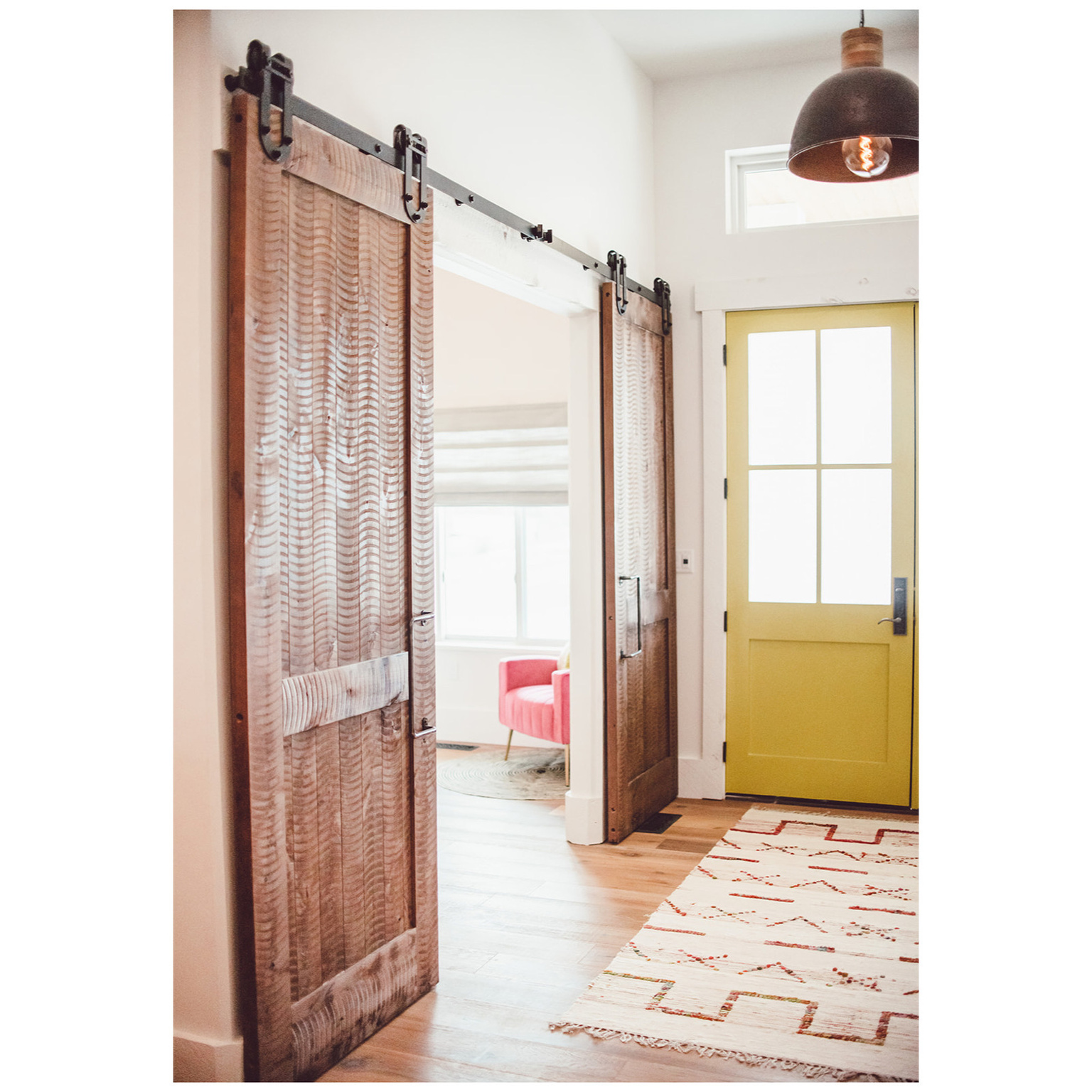 Doorway featuring light wood finished floors and a barn door