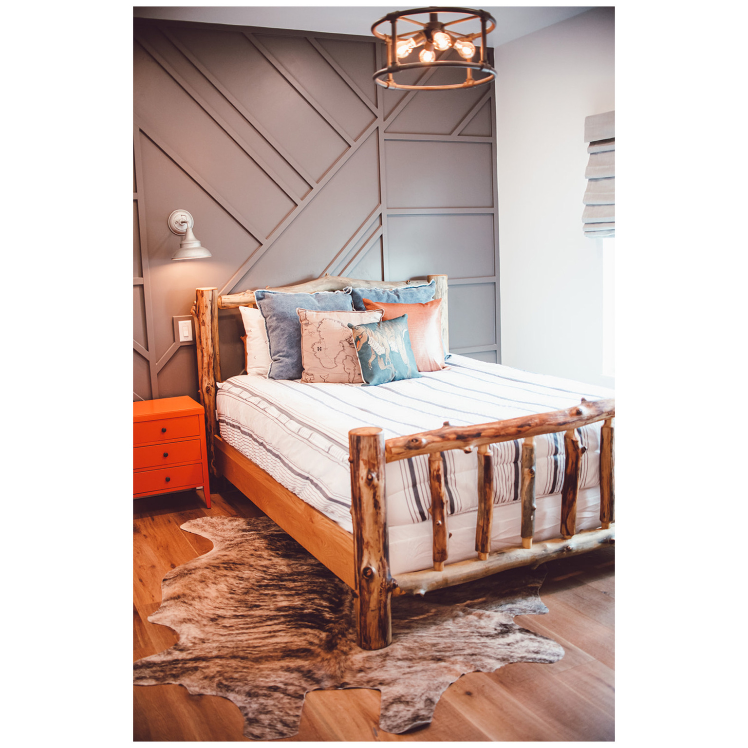 Bedroom featuring wood finished floors and a decorative wall