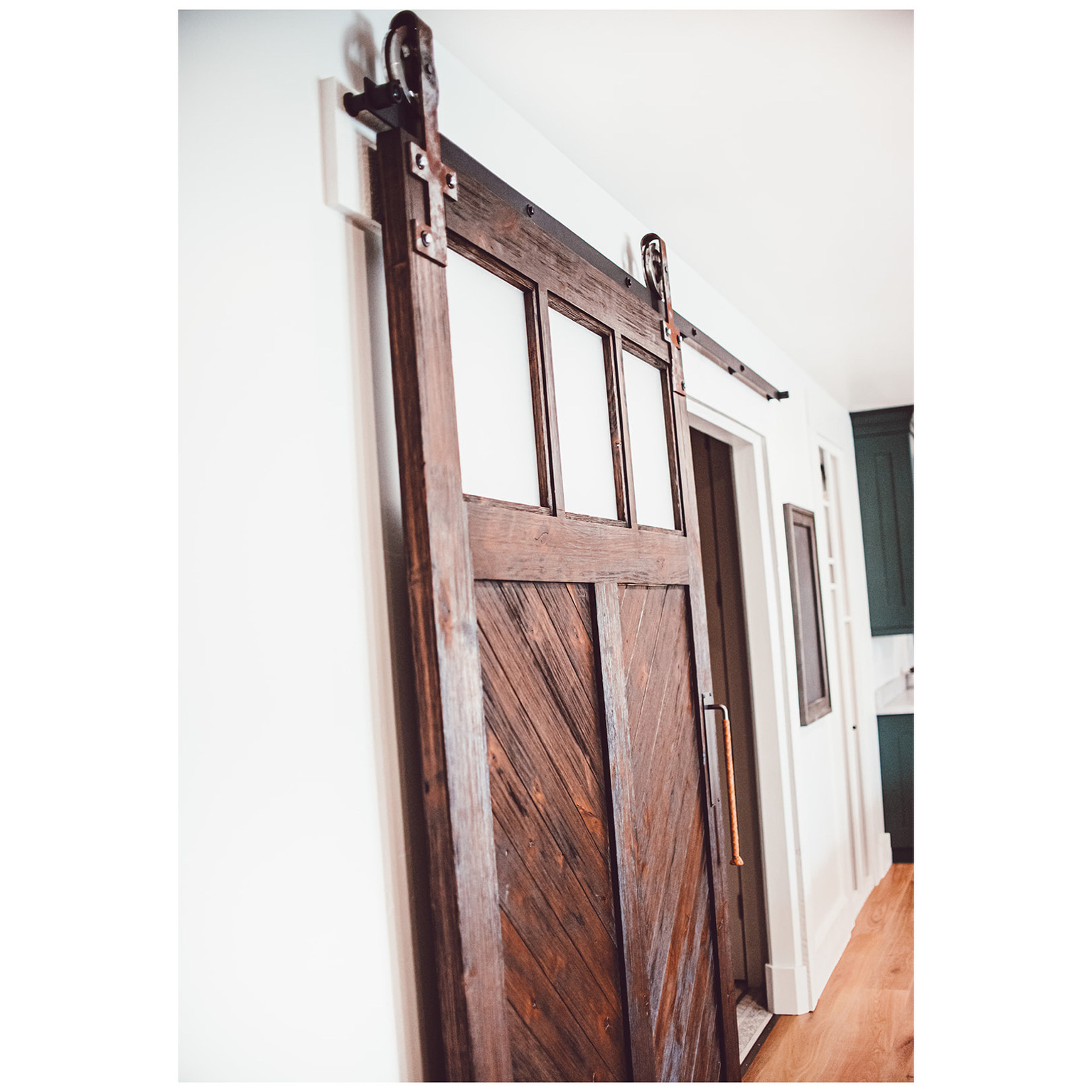 Details featuring a barn door and wood finished floors